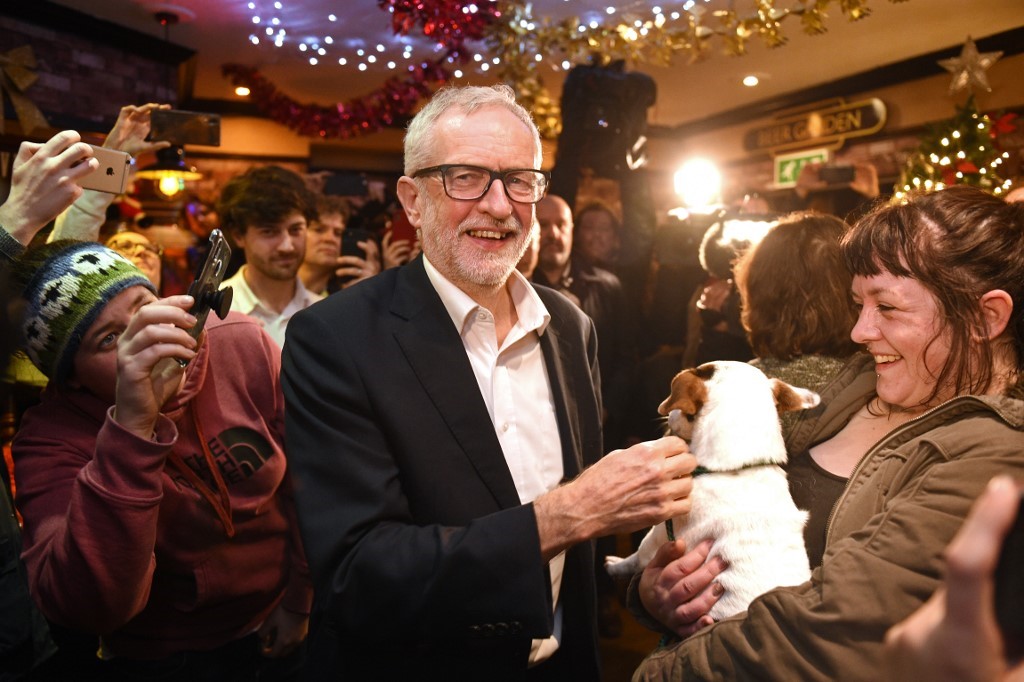 Britain's main opposition Labour party leader Jeremy Corbyn (C) meets supporters during a campaign event in Carlisle, north-west England on December 10, 2019. Britain will go to the polls on December 12, 2019 to vote in a pre-Christmas general election.