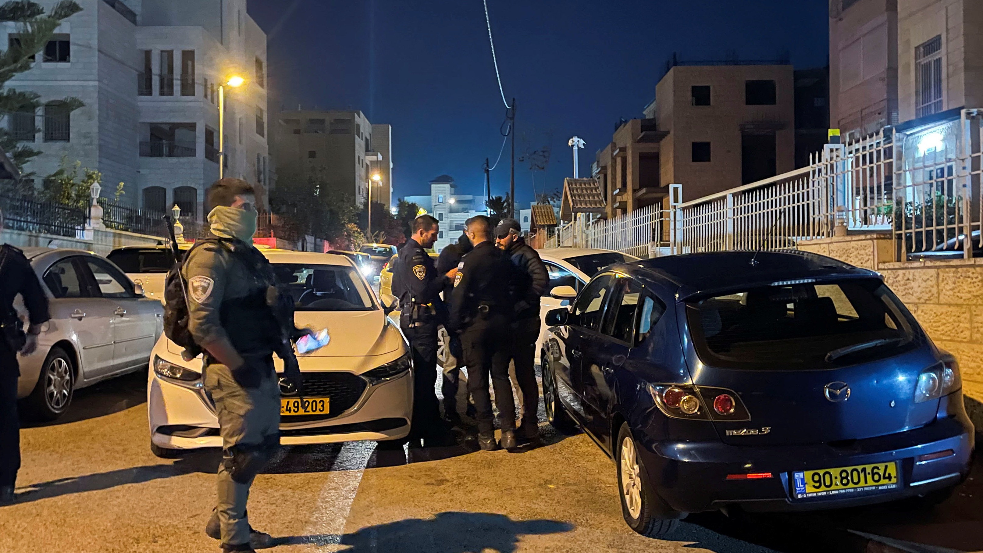 Israeli Policemen stand guard during a raid of a Palestinian prisoner's house who is set to be released today as part of a hostages-prisoners swap deal between Hamas and Israel in Jerusalem, November 24, 2023.