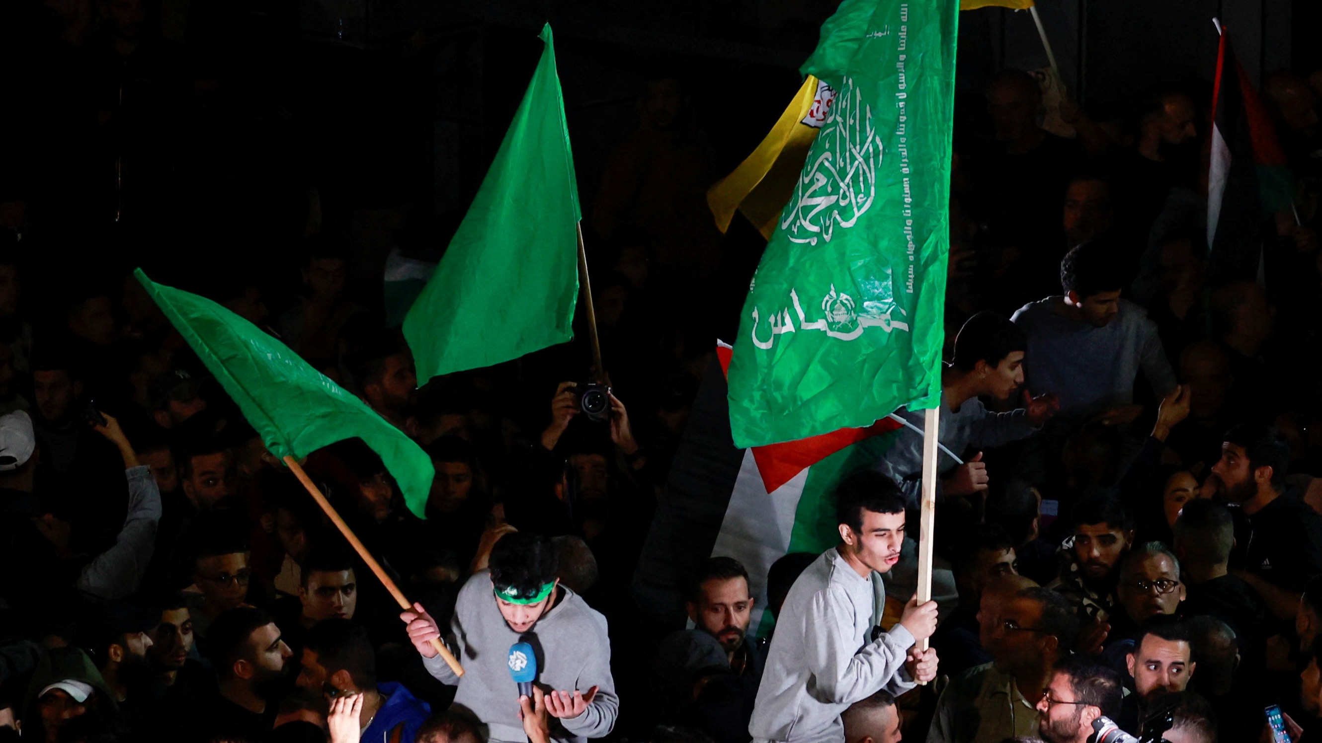 Palestinians released from Israeli prison holding flags in the occupied West Bank (Reuters)