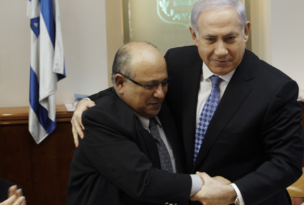 Israeli Prime Minister Benjamin Netanyahu embraces outgoing Mossad director Meir Dagan in Jerusalem on 2 January 2011 (AFP)