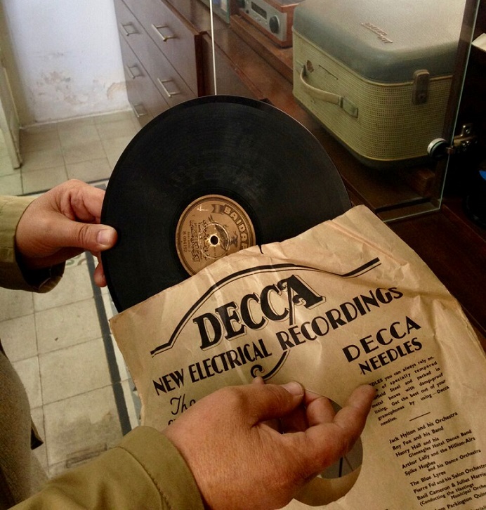 ​  Jalal pulls out the sleeve of an old Decca recording from the Nawa collection (MEE)  ​