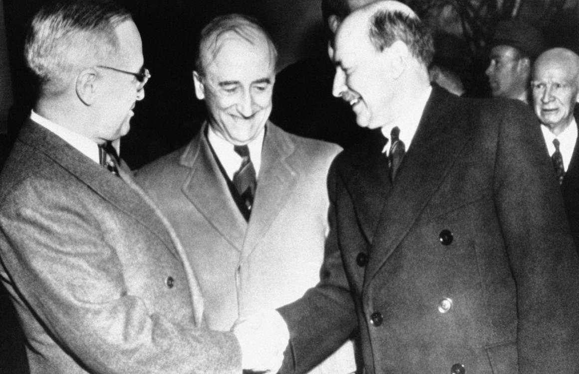 President Harry S. Truman (left) shakes hands with British Prime Minister Clement Attlee on the steps of the White House on Nov. 10, 1945, as Secretary of State James Byrnes looks on. | AP Photo