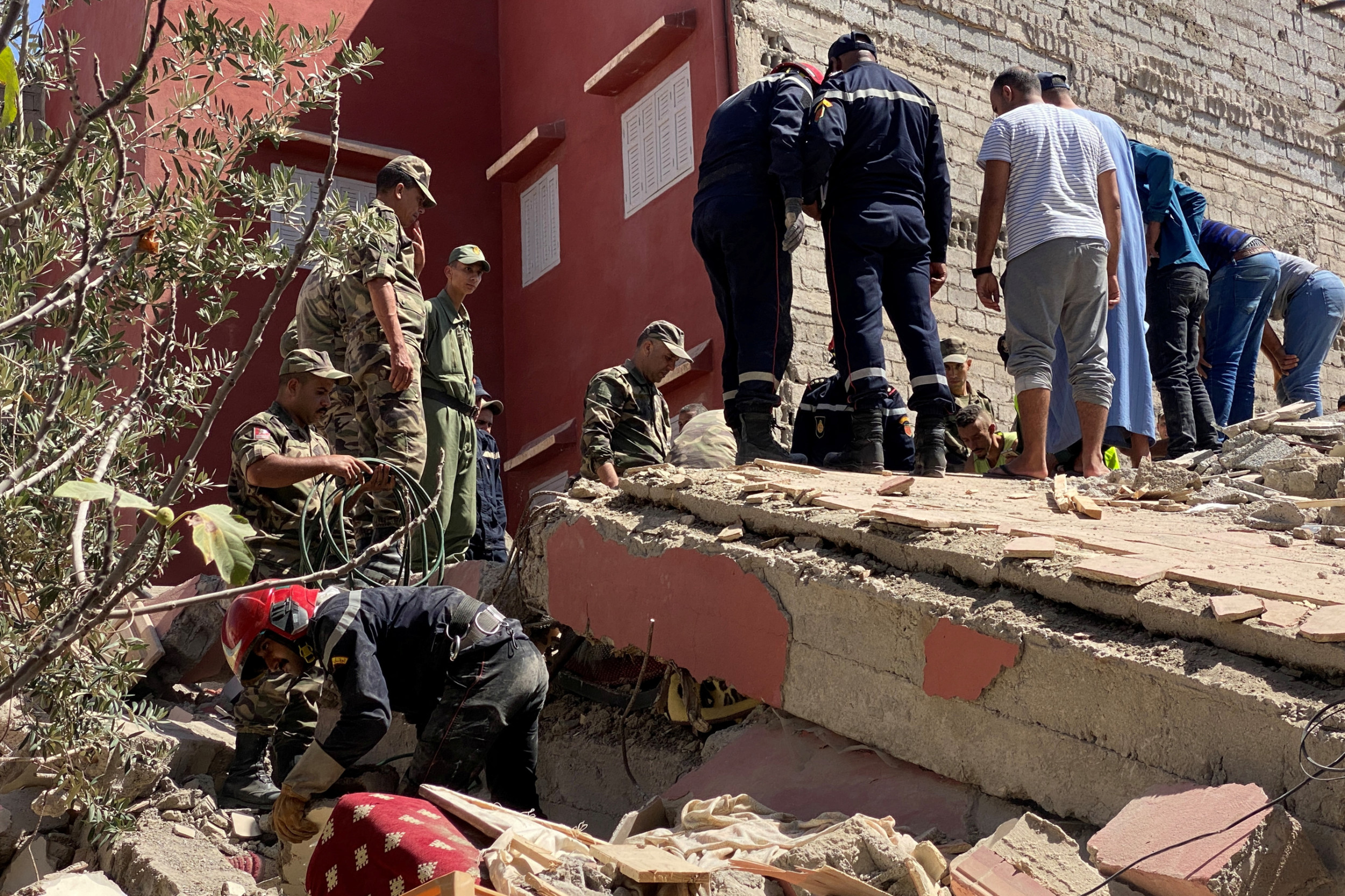 Moroccan rescuers carry a search operation in Amizmiz town located approximately 55 kilometers south of Marrakesh (Reuters)