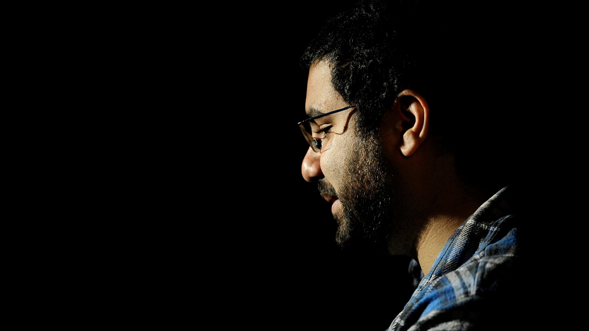 Egyptian blogger and activist Alaa Abdel Fattah gives a TV interview at his house in Cairo on December 26, 2011, 