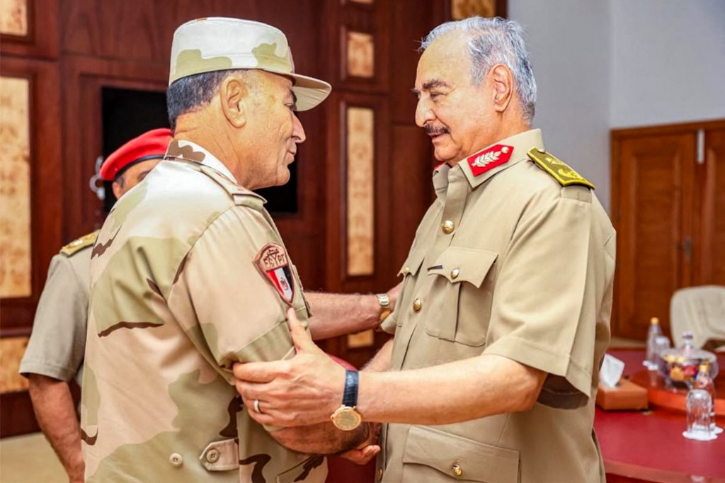 This picture released by the official Facebook page of Egypt's Military Spokesman on September 12, 2023 shows Libya's eastern military strongman Khalifa Haftar (R) receiving the Chief of Staff of the Egyptian Armed Forces Lieutenant General Osama Askar in Libya's eastern city of Benghazi, after the latter arrived with a military delegation and emergency disaster relief aid in the wake of massive floods by Mediterranean storm "Daniel".