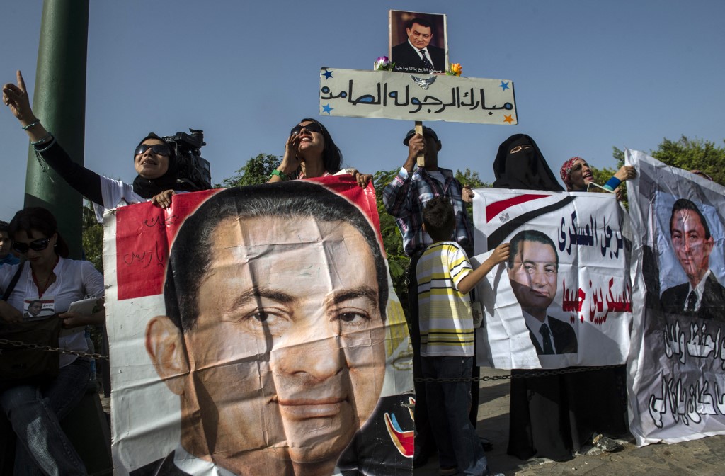 Egyptians hold portraits of toppled President Hosni Mubarak in Cairo in 2014 (AFP)