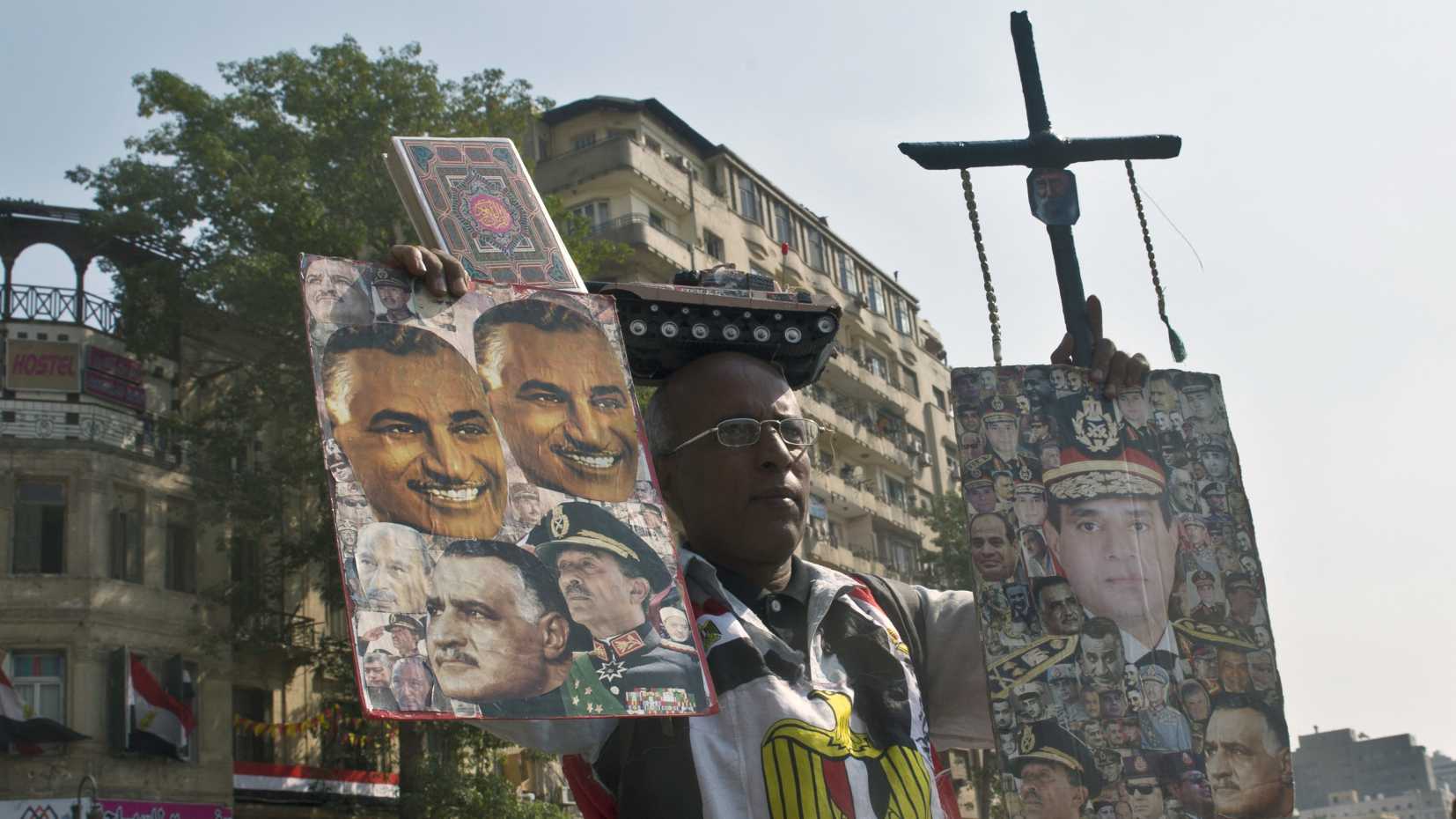 An Egyptian hold posters, one depicting Abdel Fattah al-Sisi (R), during a gathering on Tahrir Square to mark the 40th anniversary of the 1973 Arab-Israeli war on October 6, 2013 in the Egyptian capital Cairo.