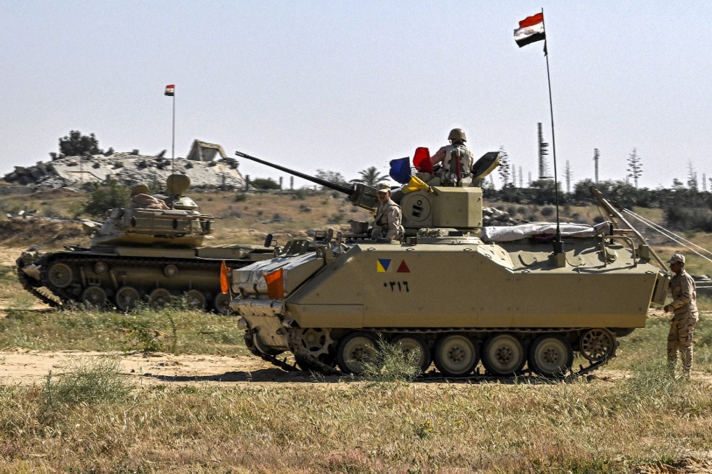 An Egyptian army M60 main battle tank and an infantry fighting vehicle (IFV) are deployed near the Egyptian side of the Rafah border crossing with the Gaza Strip on March 23, 2024