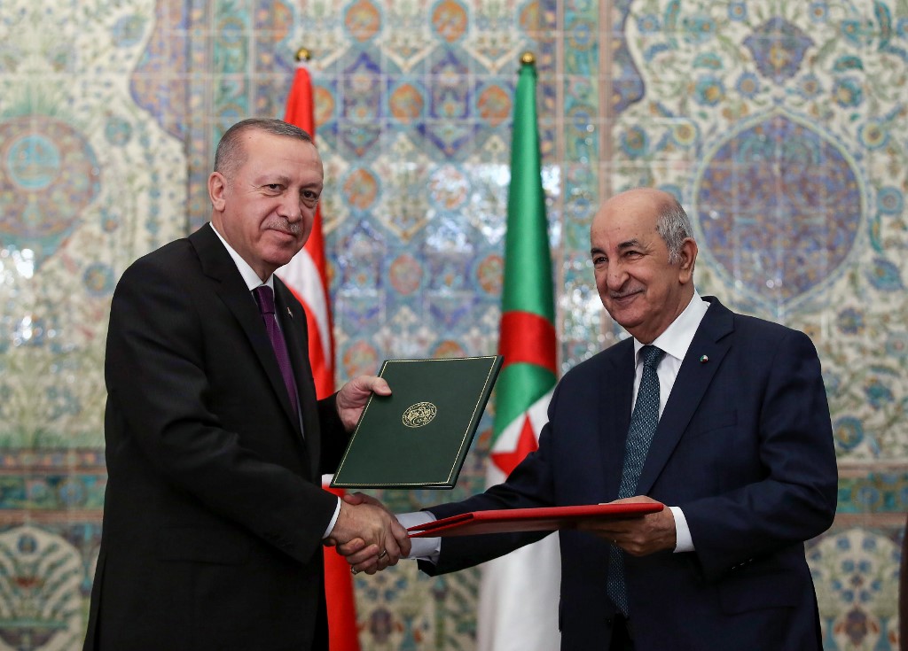 Erdogan and Algerian President Abdelmadjid Tebboune sign bilateral agreements in Algiers on 26 January (Murat Kula/Turkish Presidential Press Service/AFP)