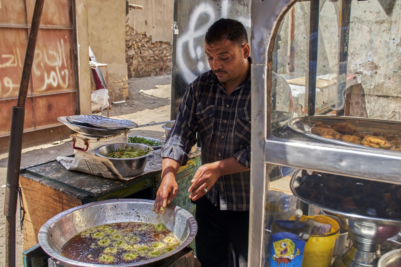 Sayed El Deeb, a vendor on Abd Al Aziz Gaweash street, whose family has been making taameya (falafel) for 50 years, in downtown Cairo, 10 April 2019 (MEE/Hamada Elrasam)