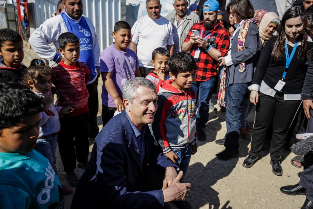 Filippo Grandi, the UN High Commissioner for Refugees, poses with Syrian refugee children at a camp in northern Lebanon in March 2019 (AFP)