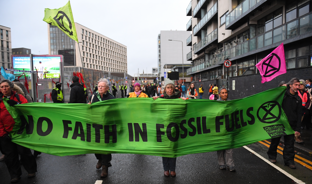 Protesters displaying a message against the use of fossil fuels,
