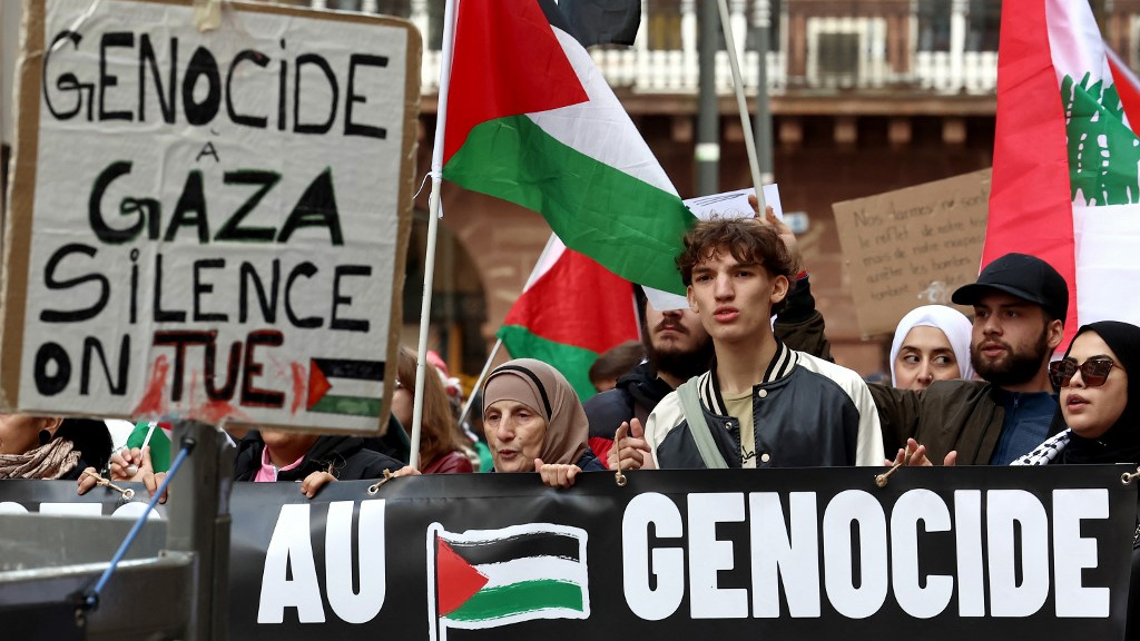 Protesters hold a placard that reads: “Genocide in Gaza silence we kill” at a demonstration against Israel’s war, in Strasbourg, France, on 5 October 2024 (Frederick Florin/AFP)