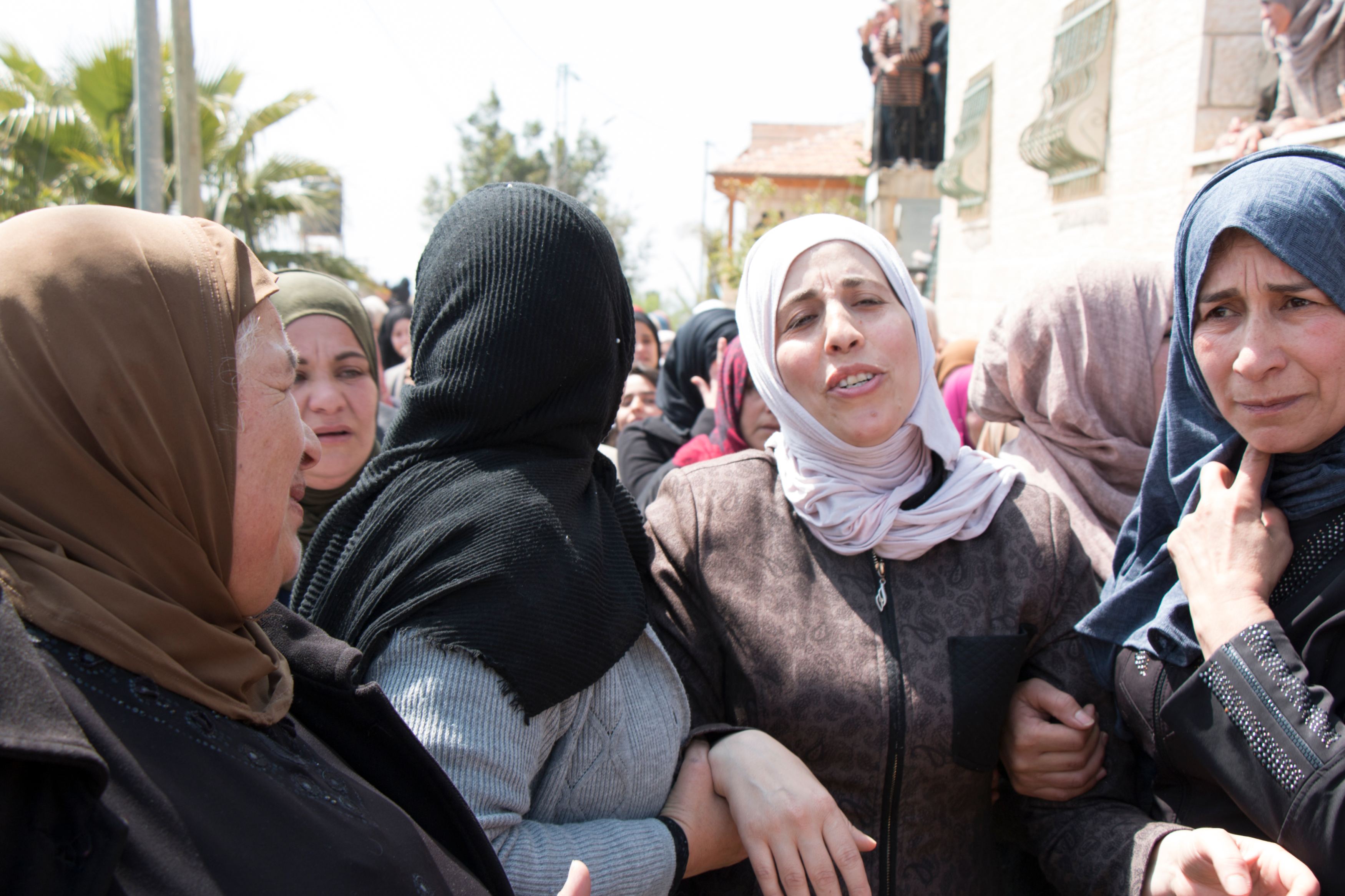 Ahmad Manasrah's mother, second from right, mourns during her son's funeral on Thursday (MEE/Akram al-Waara)