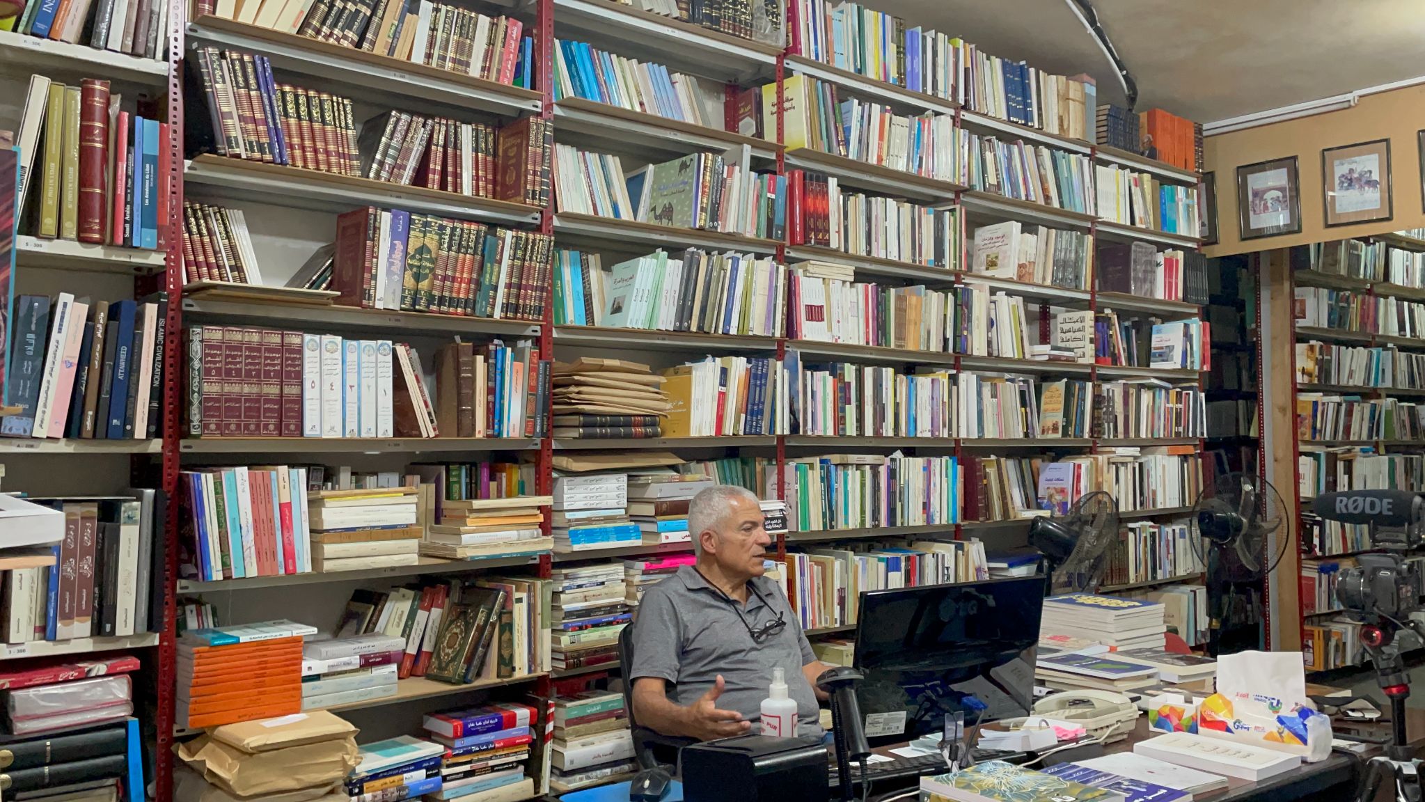 Abboudi Abou Jaoude, owner of Al-Furat bookshop , talks to visitors about economic crisis (AJ Naddaf)