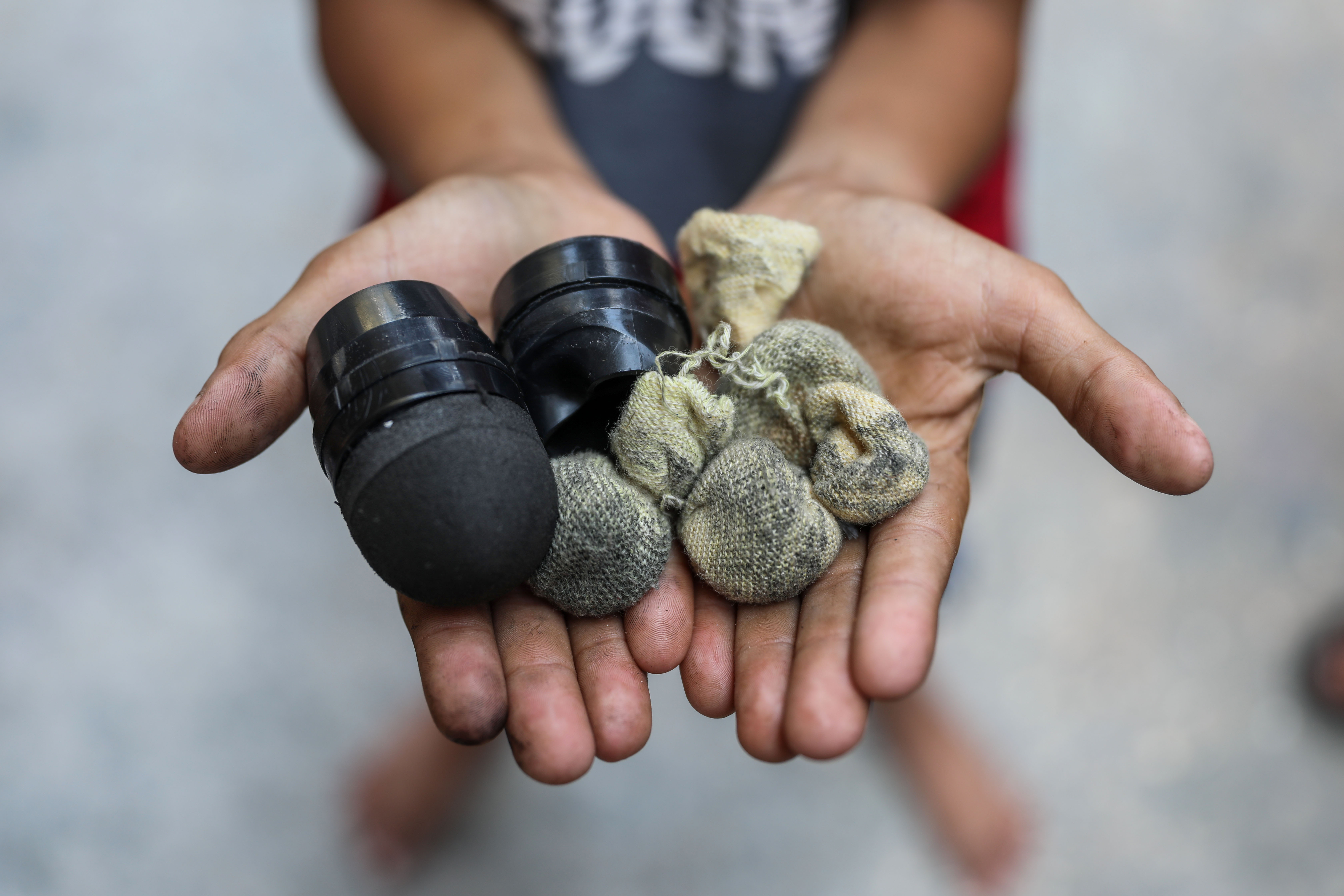 Rubber-coated bullets used by the Israeli navy against fishermen off the coast of Gaza held by a Palestinian child on 16 June 2022. (MEE/Mohammed al-Hajjar)
