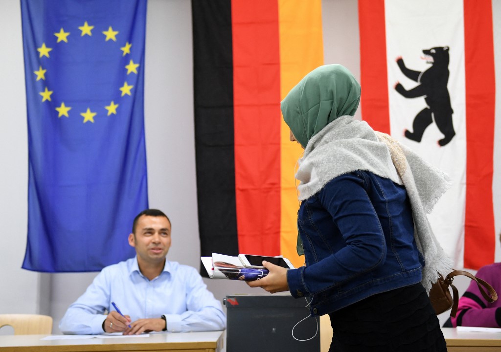 A Muslim woman casts a ballot in Berlin during Germany’s 2017 election (AFP)