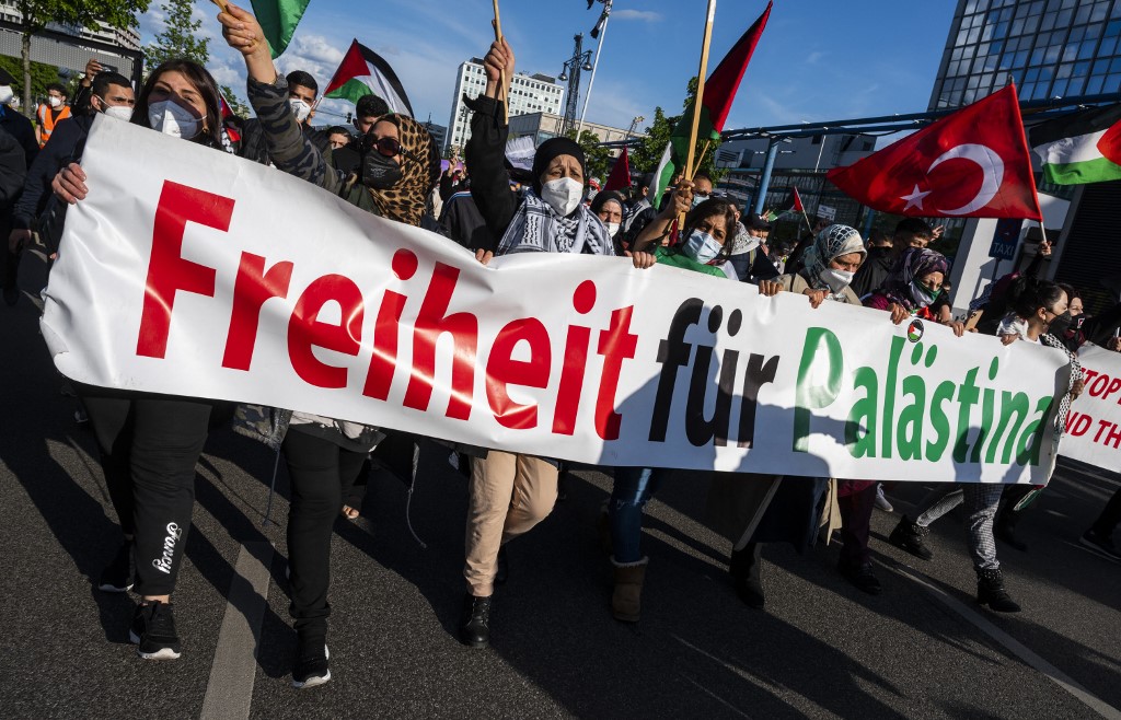 Protesters hold a banner reading ‘Freedom for Palestine’ in Berlin on 19 May 2021 (AFP)