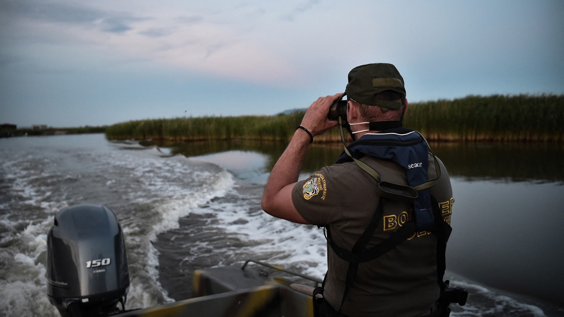 A Police officer patrols the delta of Evros river on a boat, near Alexandroupoli, along the Greek-Turkish border, on June 8, 2021. 