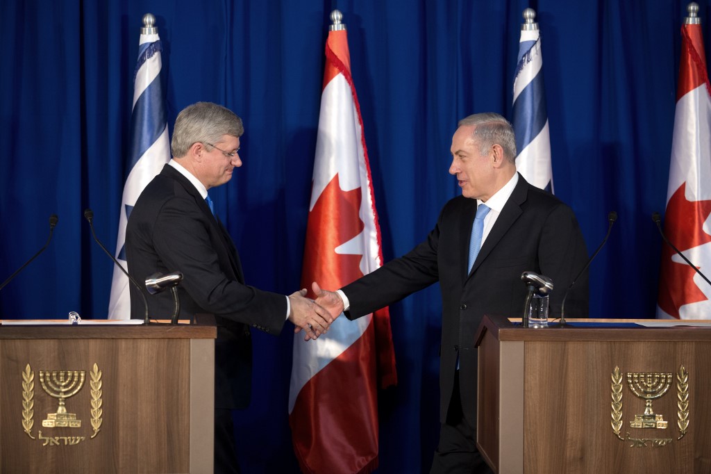 Israeli Prime Minister Benjamin Netanyahu and former Canadian Prime Minister Stephen Harper shake hands in Jerusalem in 2014 (AFP)