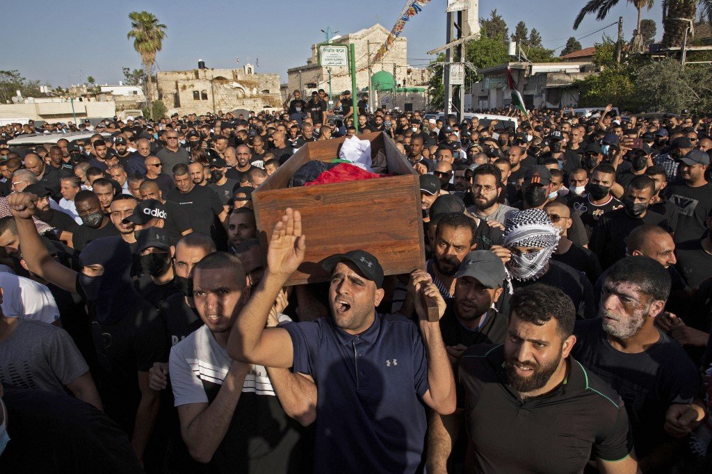 Des Palestiniens en deuil assistent aux funérailles de Moussa Hassouna, le 11 mai 2021 (AFP)