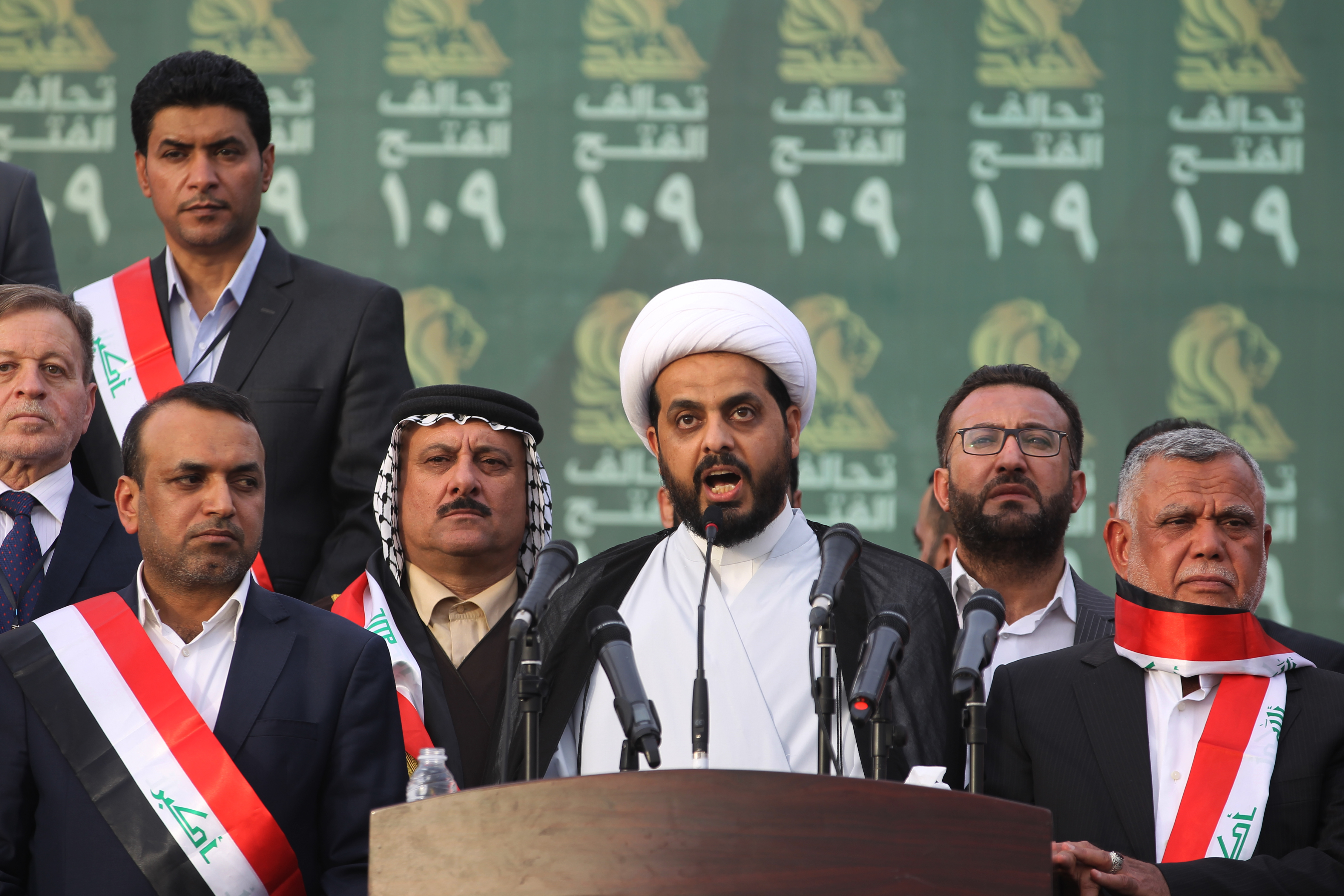 Qais al-Khazali, centre, leader of the Asa'ib Ahl al-Haq, gives a speech in Baghdad during a campaign rally for the Fateh Alliance, a coalition of Iranian-supported militia groups (AFP)