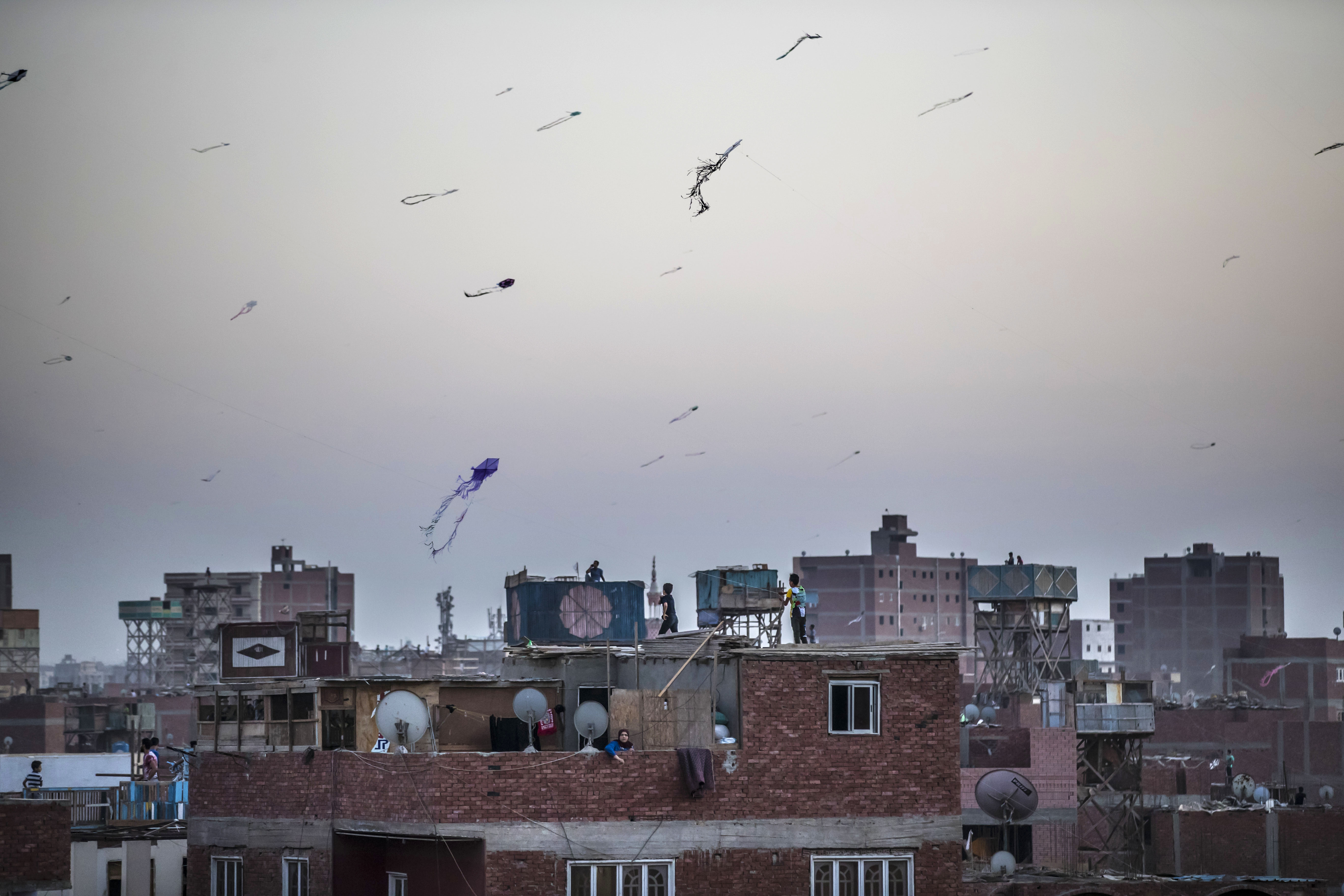 Egyptian youths fly kites in the Saft el-Laban district of the Egyptian city of Giza, near the capital Cairo (AFP)
