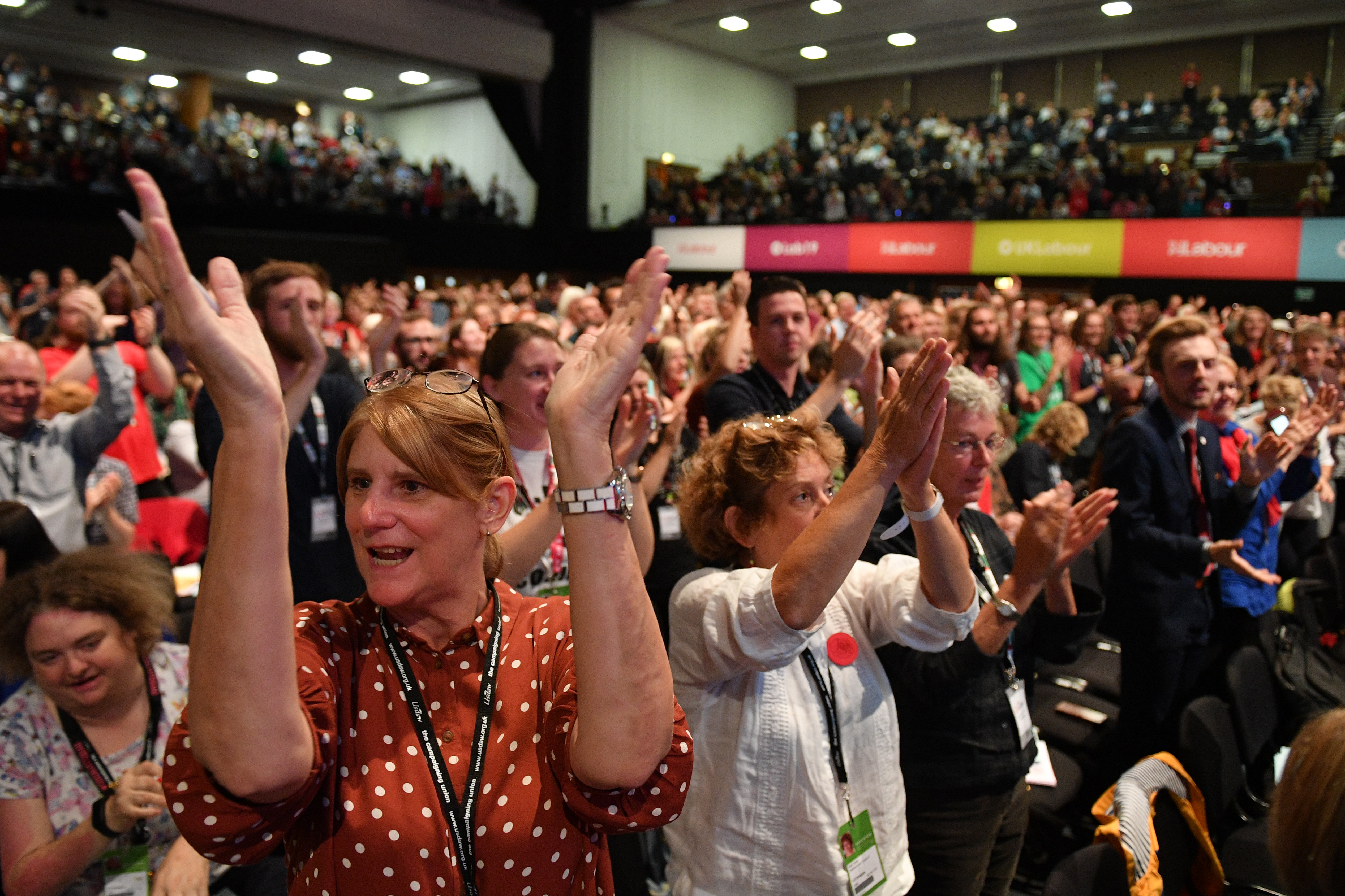 A standing ovation is given for Unite union general secretary Len McCluskey after he delivers a speech at the Labour party conference in Brighton (AFP)