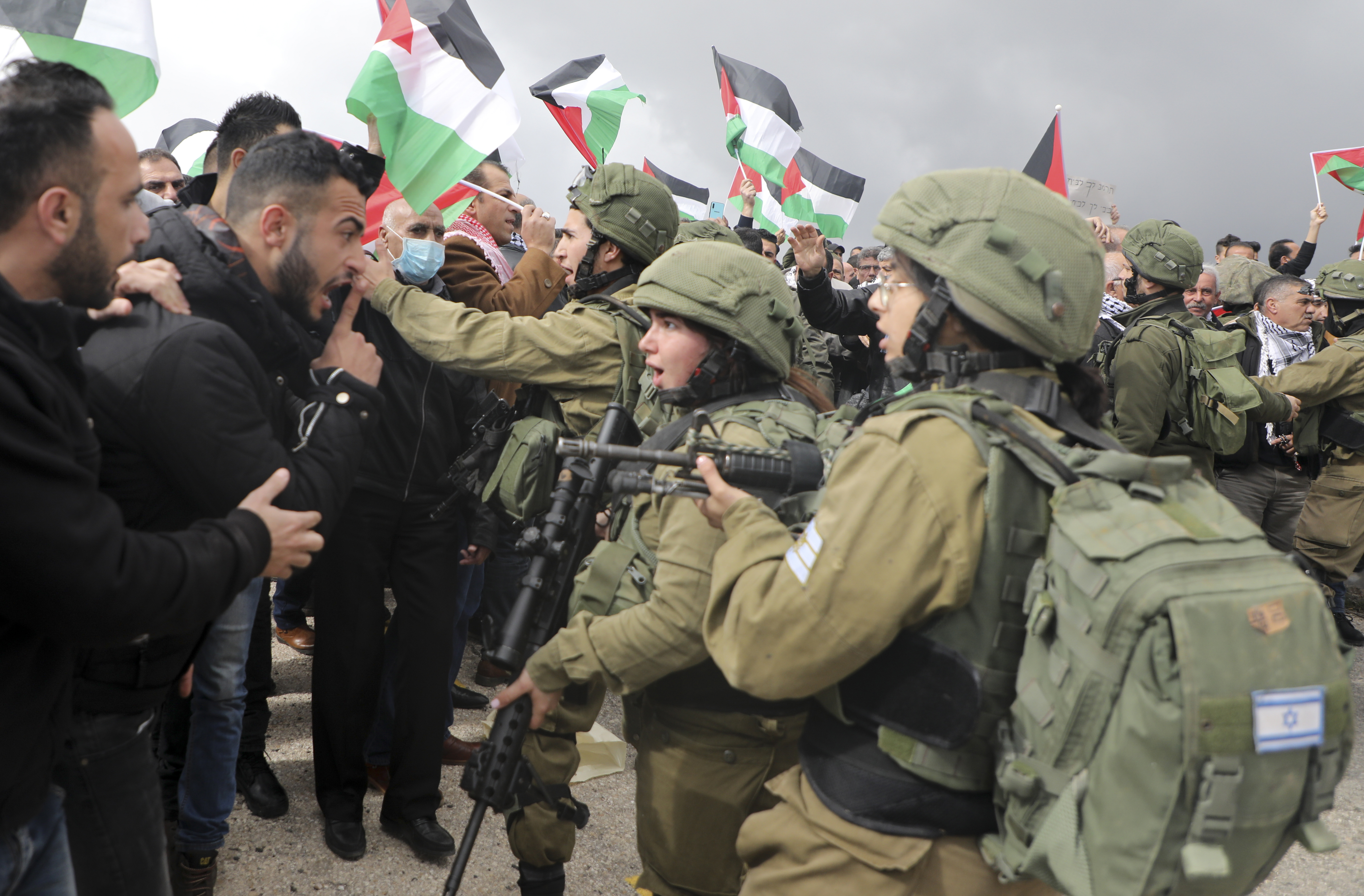 Palestinian protesters confront Israeli soldiers during a protest in the occupied West Bank on 29 January 2020 (AFP)
