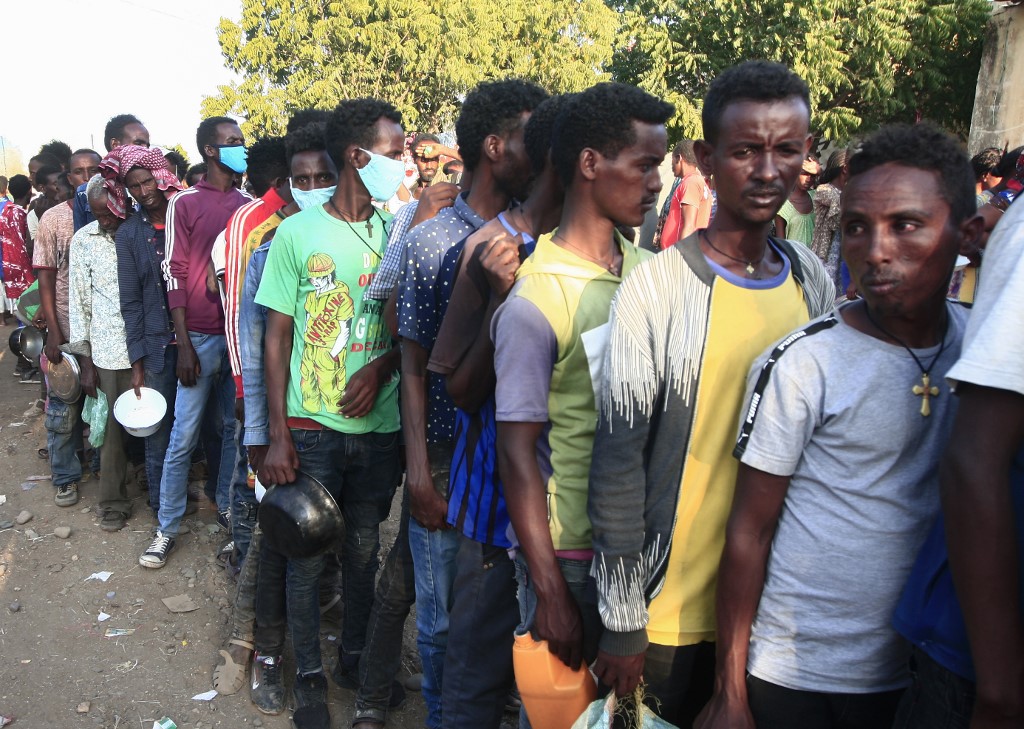 Ethiopians wait in line for food aid after fleeing the Tigray region in northern Ethiopia (AFP) 
