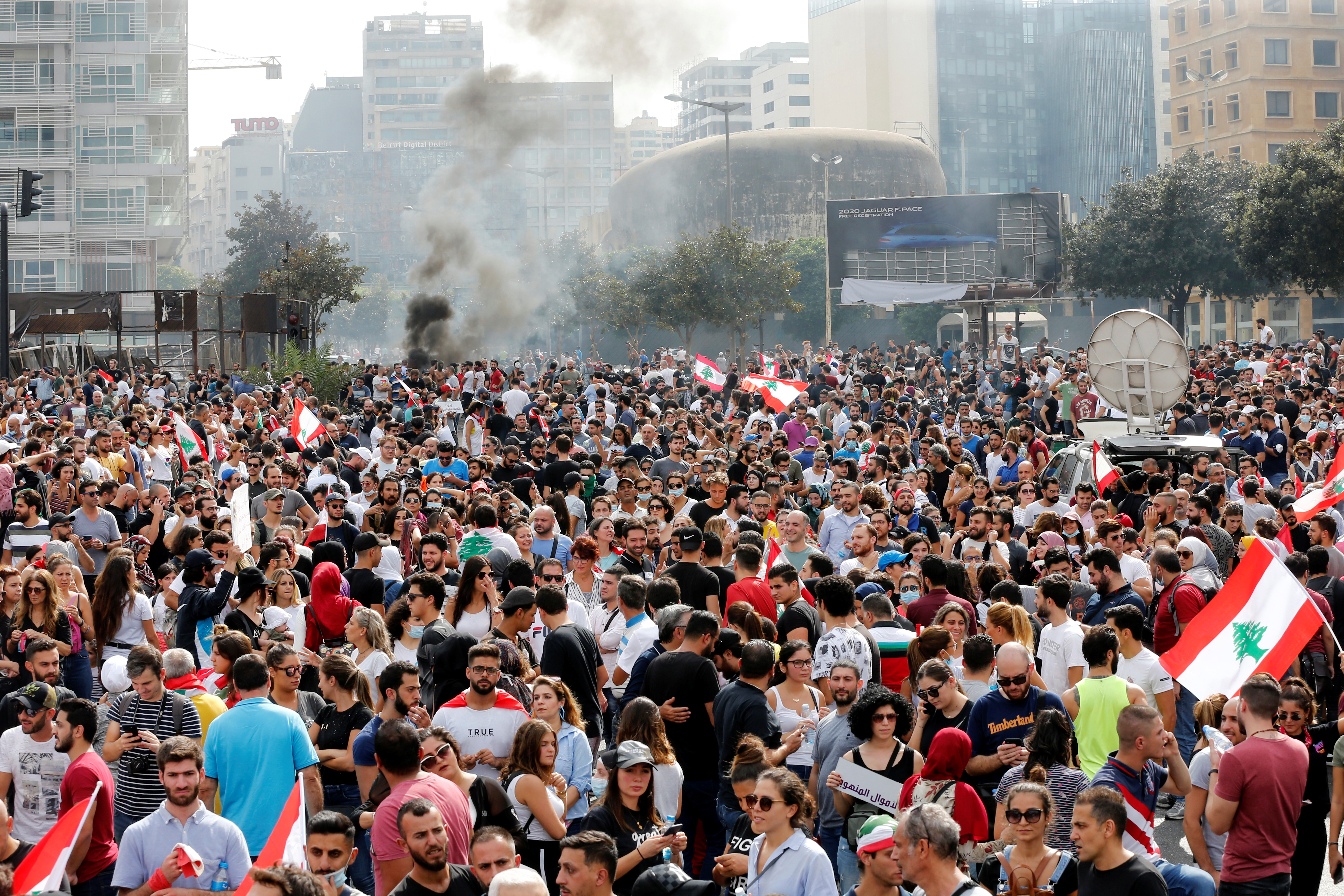 Smoke rises as demonstrators gather during a protest in Beirut over deteriorating economic situation on 18 October (Reuters)