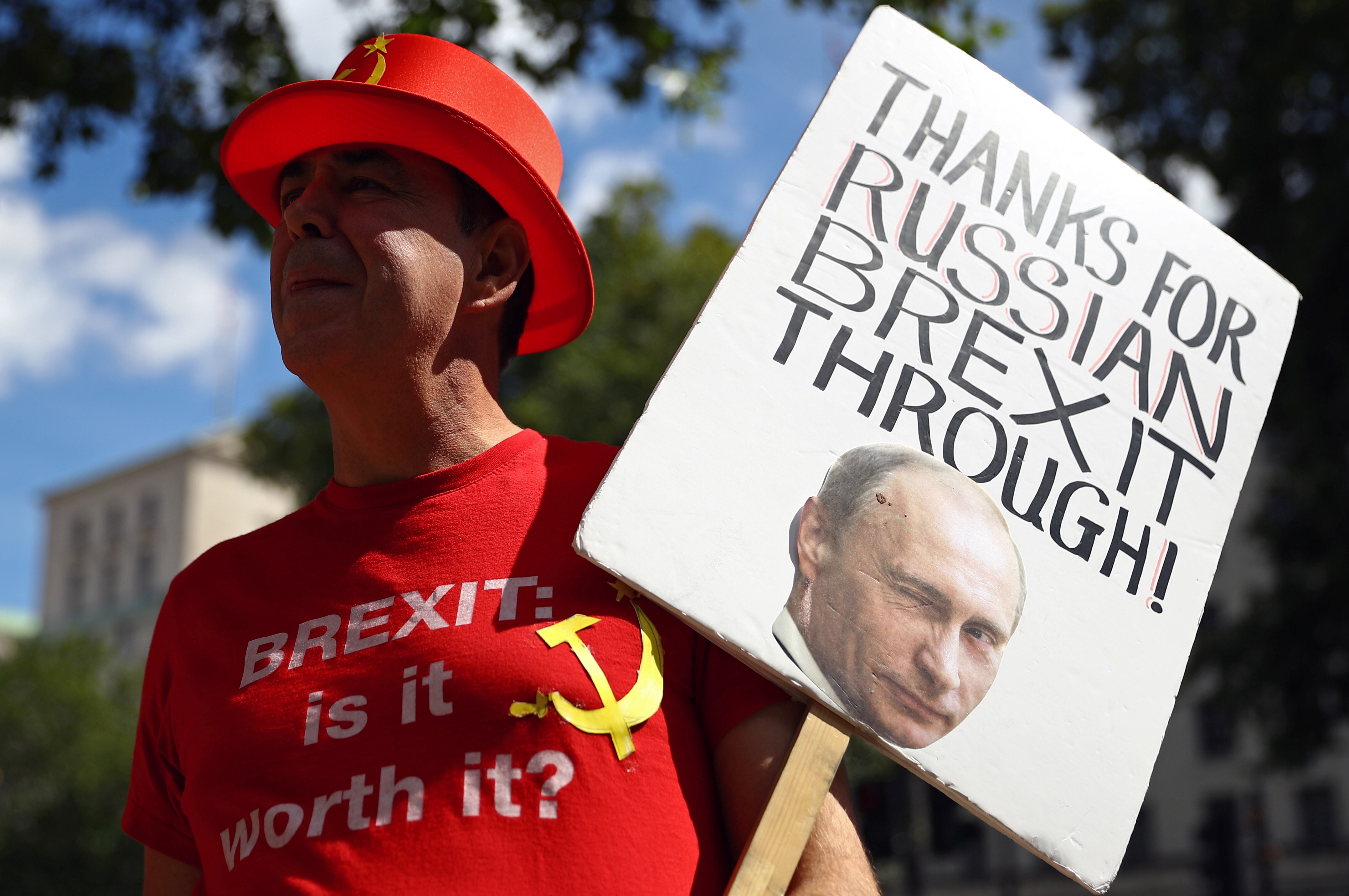 Anti-Brexit demonstrator holds a placard as he protests outside Downing Street in London, Britain on 21 July (Reuters)