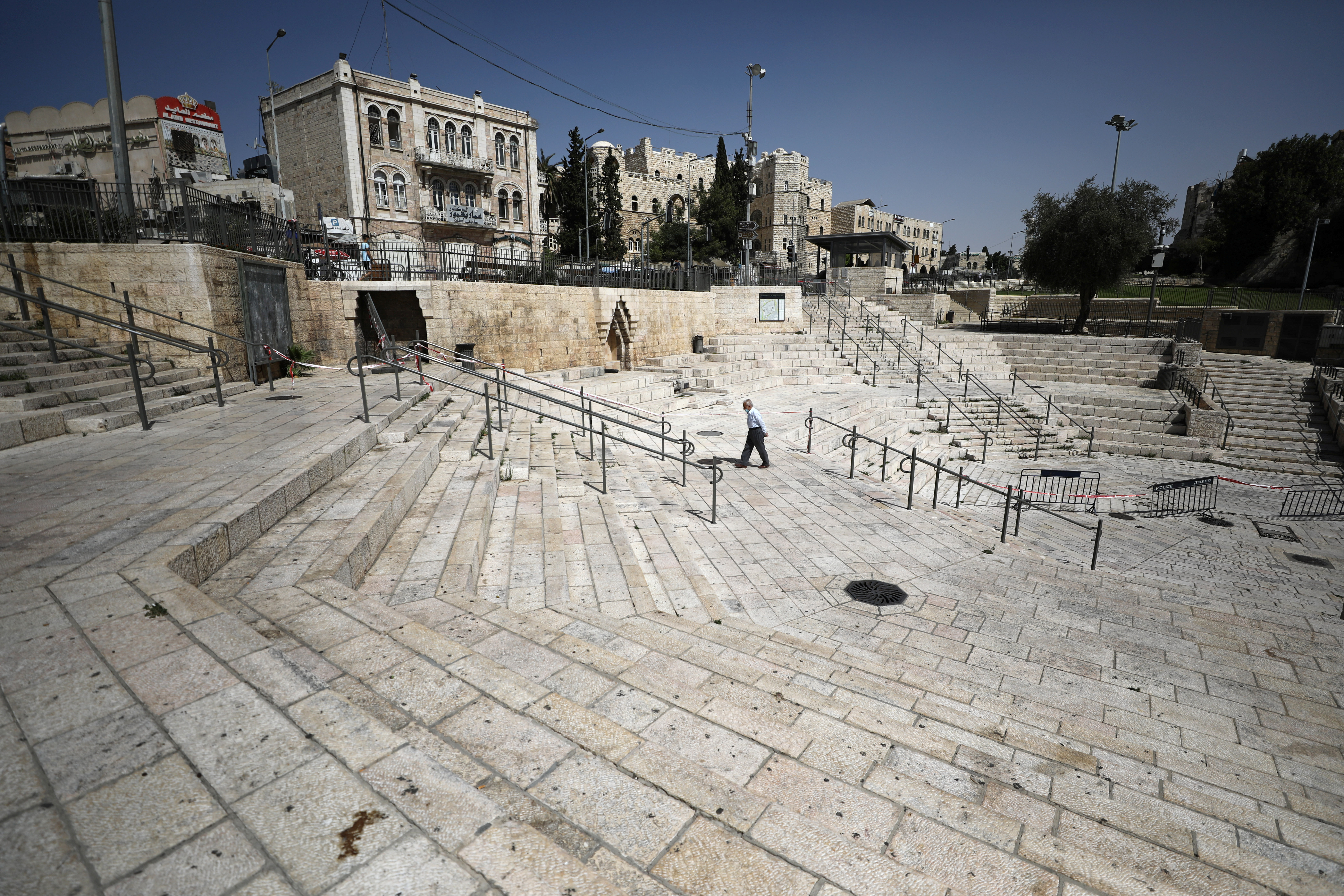 A man walks through the deserted plaza of Damascus Gate as Israel imposes a second nationwide coronavirus lockdown amid a rise in infections (Reuters)