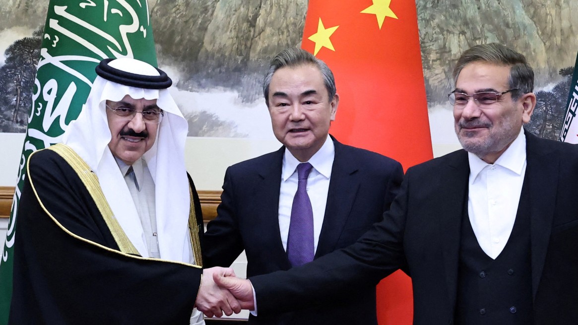China's Wang Yi, Iran's Ali Shamkhani and Saudi Arabia's Musaad bin Mohammed Al Aiban meet in Beijing on 10 March (Reuters)