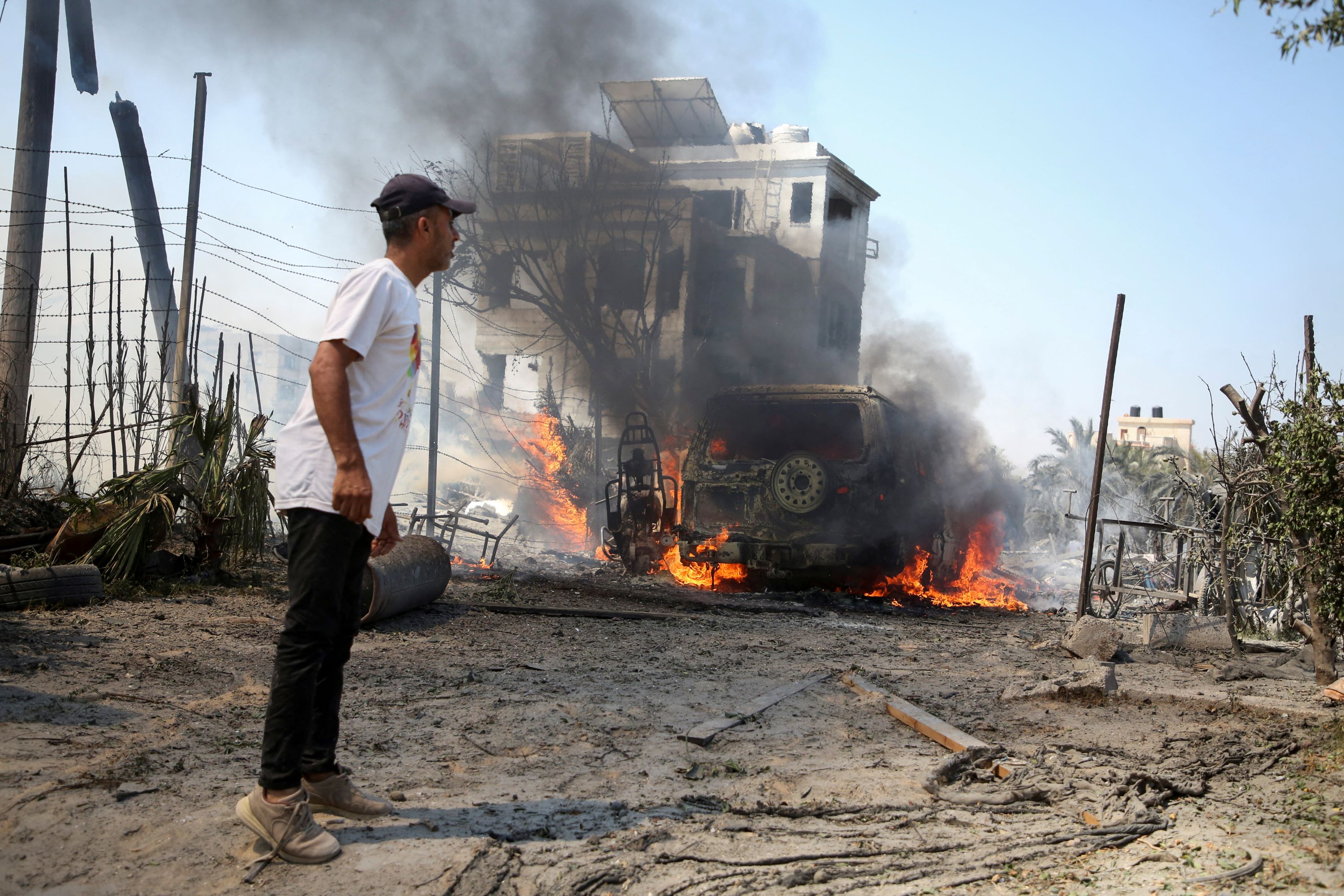 A man looks on at the site of what Palestinians say was an Israeli strike at a tent camp in the Mawasi area of Khan Younis in the southern Gaza Strip, 13 July 2024 (Hatem Khaled / Reuters)