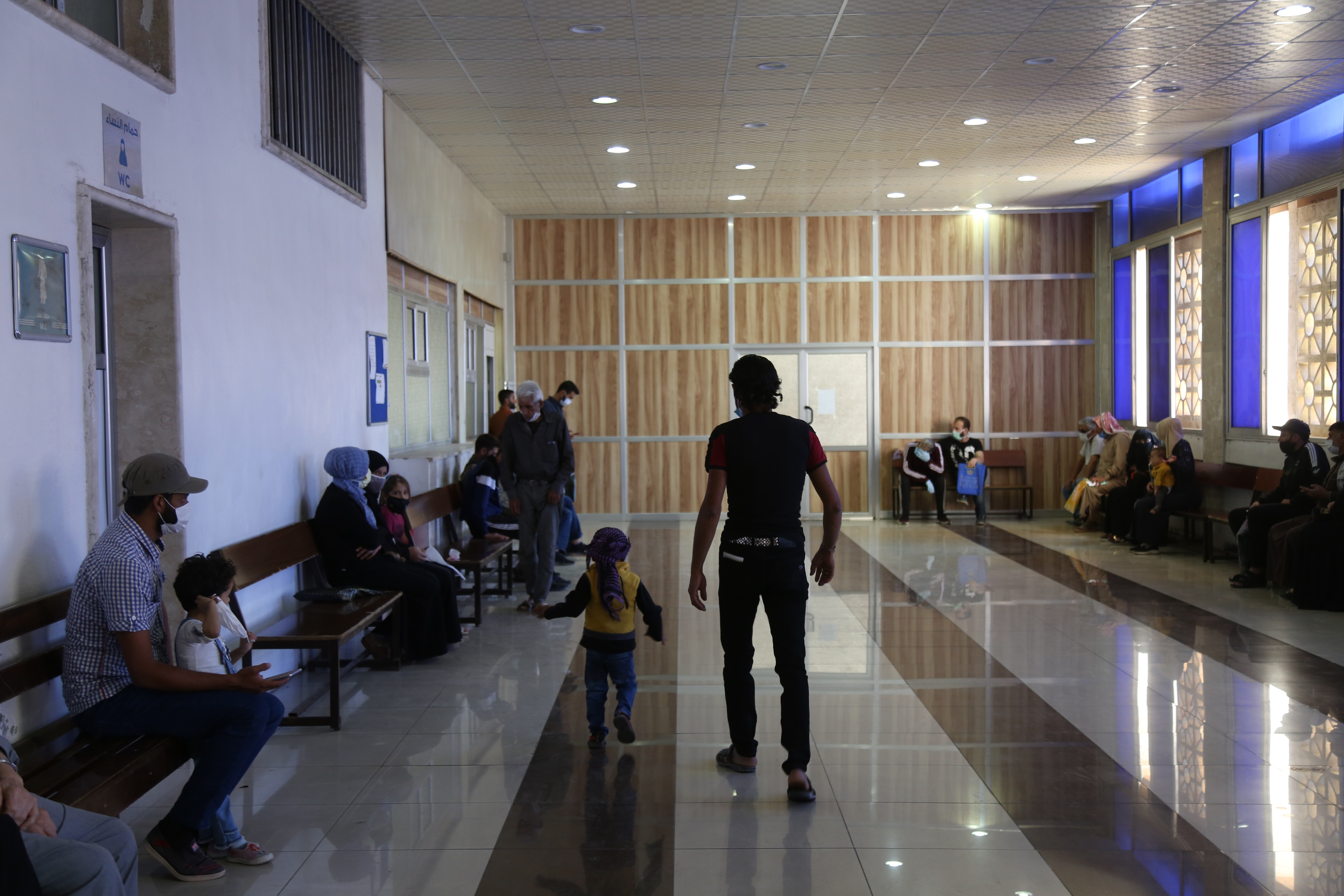 Syrians wait at the Medical Coordination Office at Bab al-Hawa with Turkey (MEE/Ali Haj Suleiman)