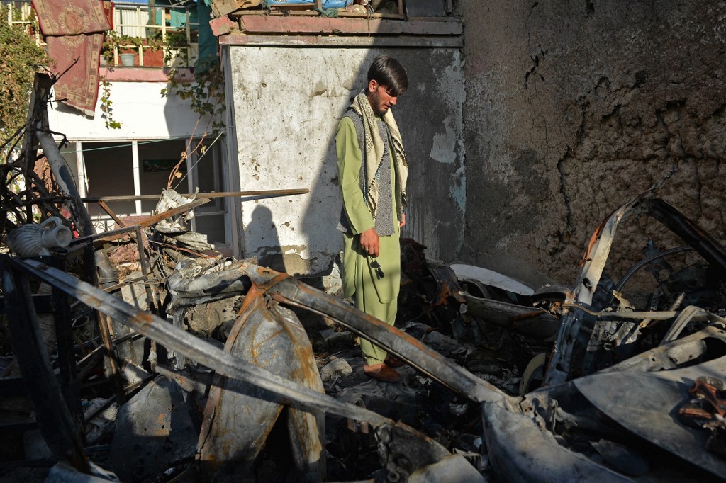 A neighbour of Ezmarai Ahmadi, stands amid the debris of Ahmadi's house that was damaged in a US drone strike in the Kwaja Burga neighbourhood of Kabul on September 18, 2021. AFP