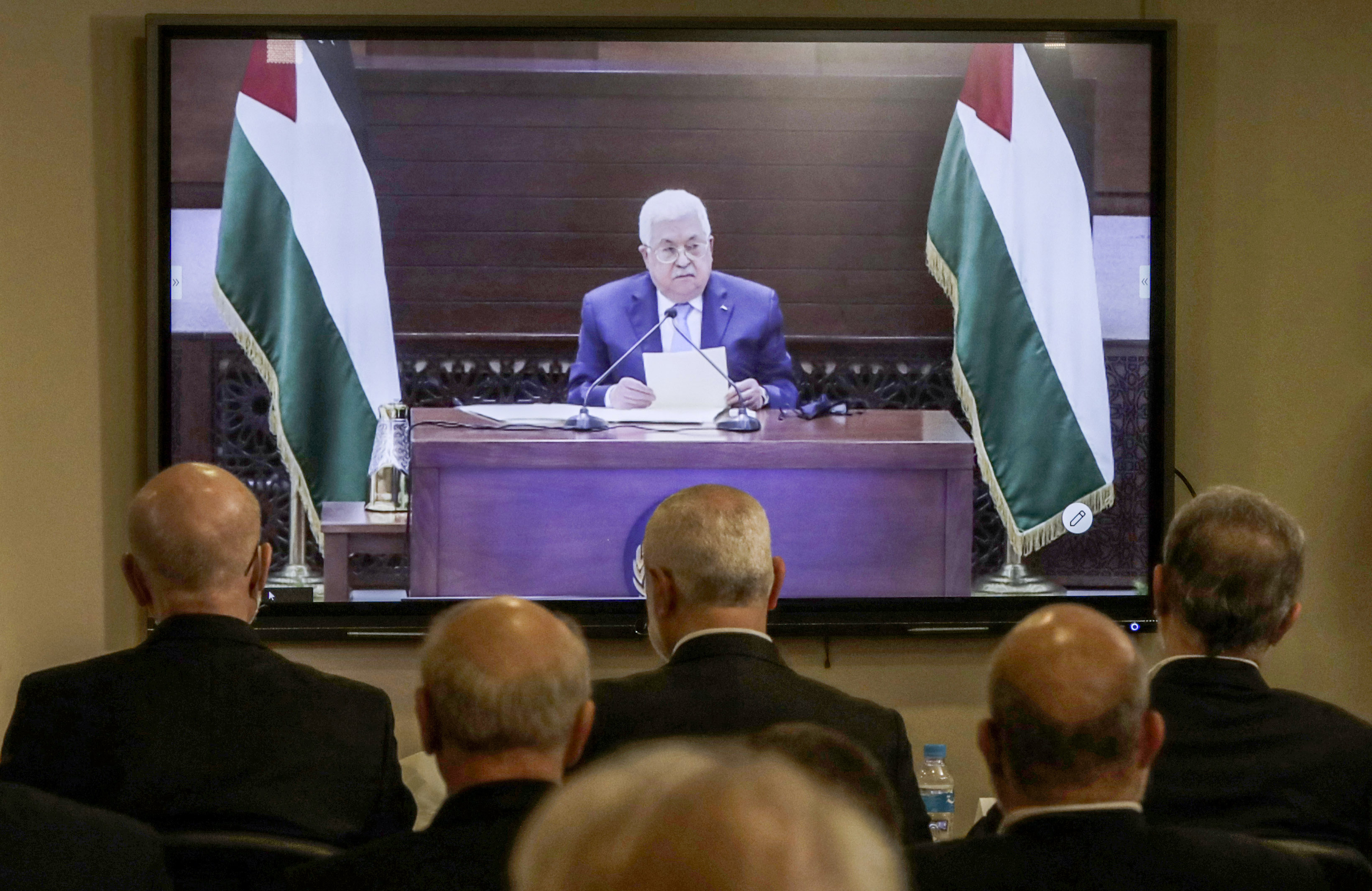 Hamas chief Ismail Haniyeh (C, front row) and representatives of Palestinian factions gather at the Palestinian embassy in Beirut on 3 September 2020 for video conference talks with Palestinian President Mahmoud Abbas (screen) in Ramallah (AFP)