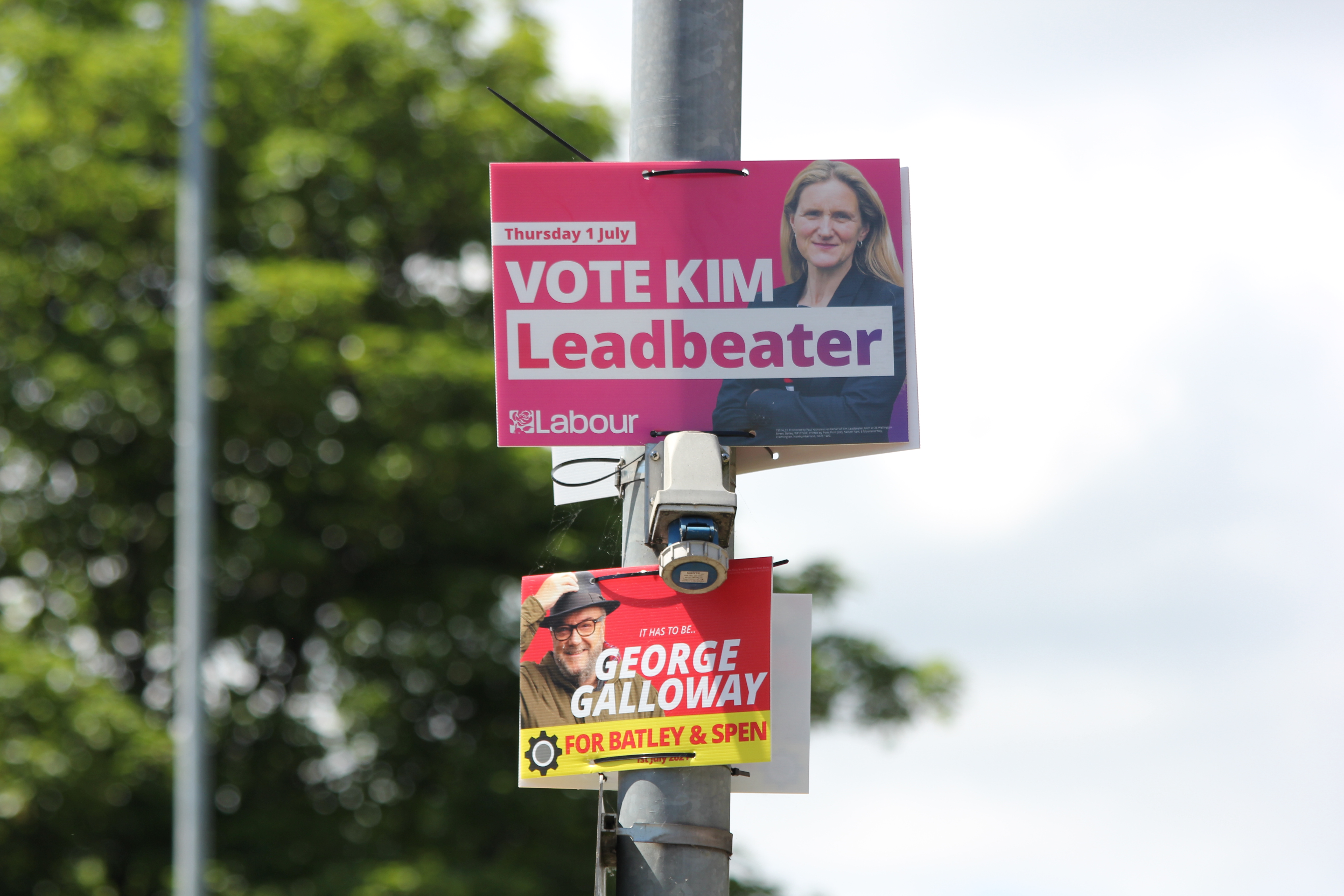 Kim Leadbetter and George Galloway campaign posters, candidates for Labour and the Workers Party of Britain respectively (MEE/Alex MacDonald)