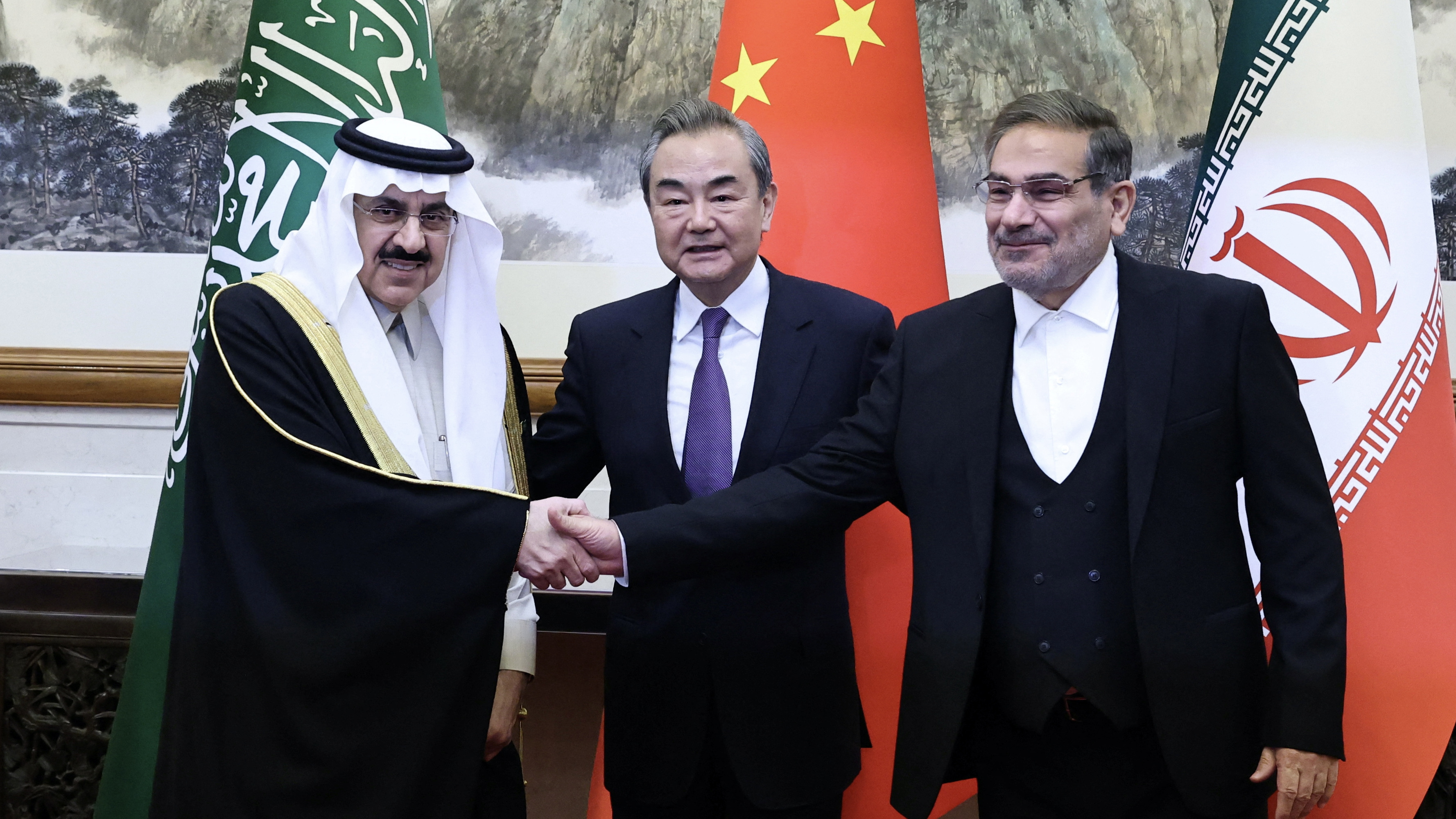 Wang Yi of the Communist Party of China, Ali Shamkhani, of Iran, Saudi Arabia's Musaad bin Mohammed Al Aiban pose in Beijing, China, 10 March 2023 (AFP)