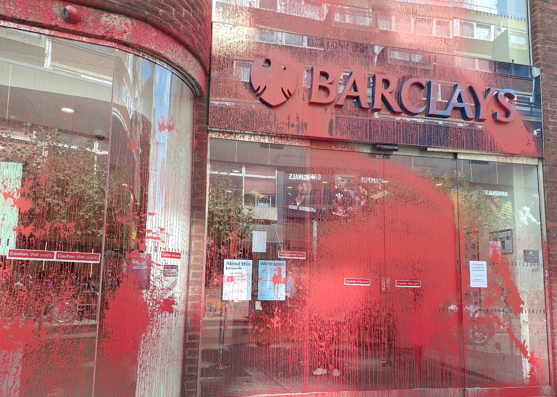 A Barclays branch in Hammersmith, west London, is seen sprayed in red paint on 12 September 2024 (Joe Gill/MEE)