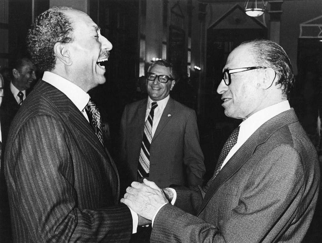 Former Egyptian President Anwar Sadat shakes hands with former Israeli Prime Minister Menachem Begin in 1977, a year before the Camp David Accords were signed (AFP)