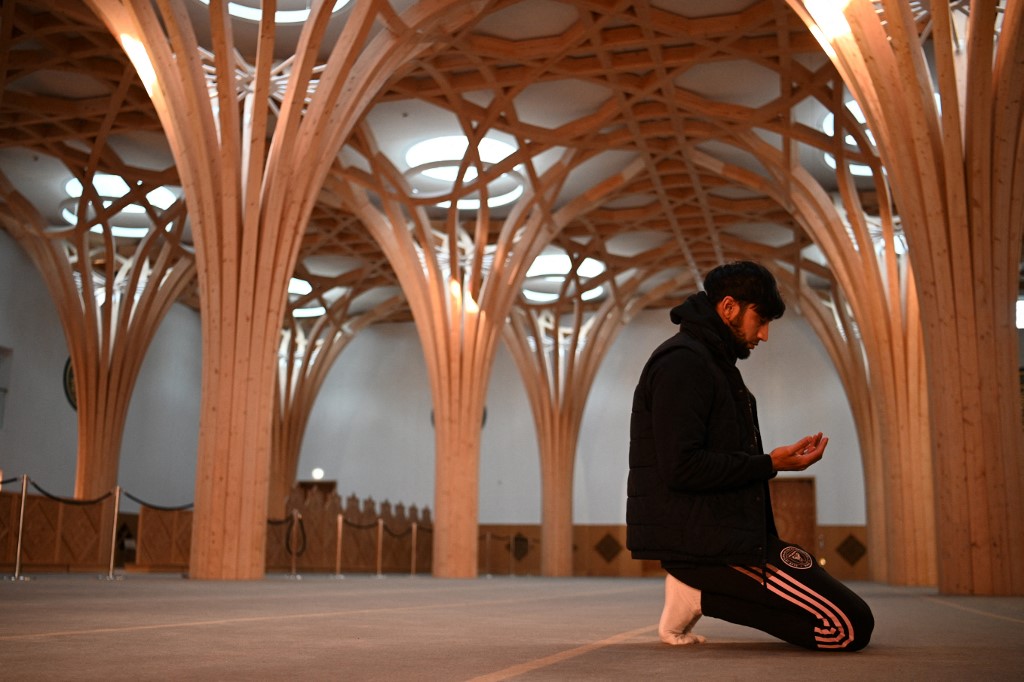 A worshipper prays at the Cambridge Central Mosque on 23 November 2021 (AFP)