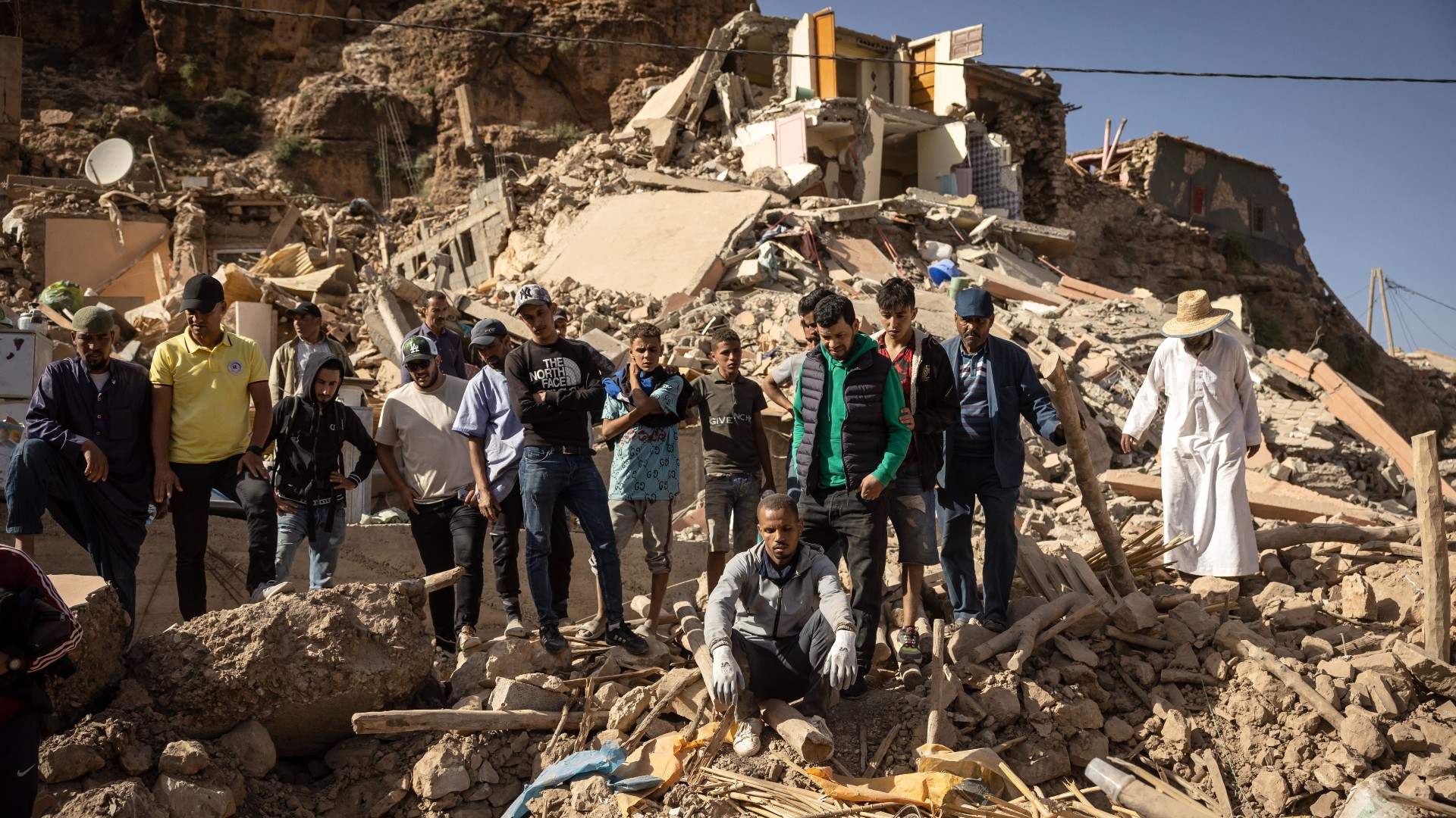 People stand in rubble of collapsed houses in village of Imi N'Tala near Amizmiz in central Morocco after deadly 6.8-magnitude earthquake, on 8 September.