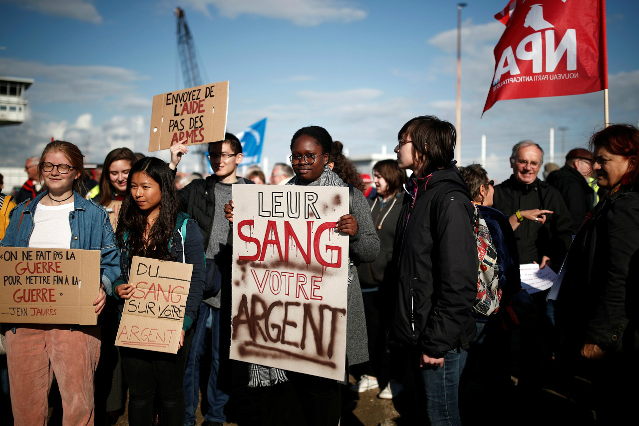 About 100 people protested at the port on Thursday, with one sign reading 'Their blood, your money' (Reuters)