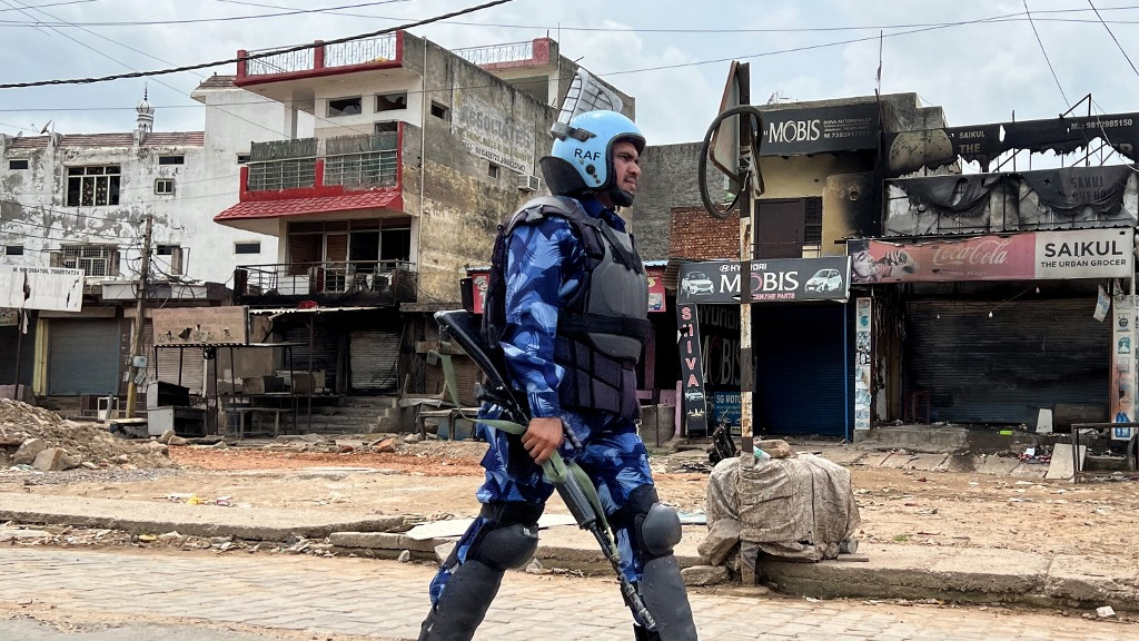 Rapid Action Force personnel patrol a street after communal riots in Nuh, in India’s Haryana state, on 2 August 2023 (AFP)
