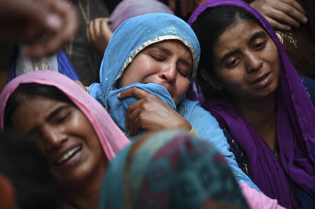 Relatives mourn a man killed in sectarian riots in India’s capital in February 2020 (AFP)