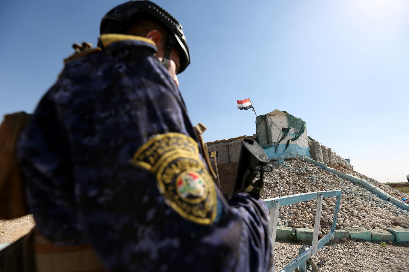 A police officer on duty at a guard post in Al-Rashad, southwestern Kirkuk province, similar to the one attacked on 4 September (MEE/Mohammed Aqeel)