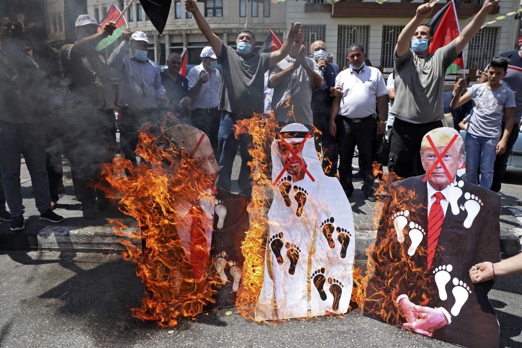 Palestinians protest the Israel-UAE deal in Nablus on 14 August (AFP)