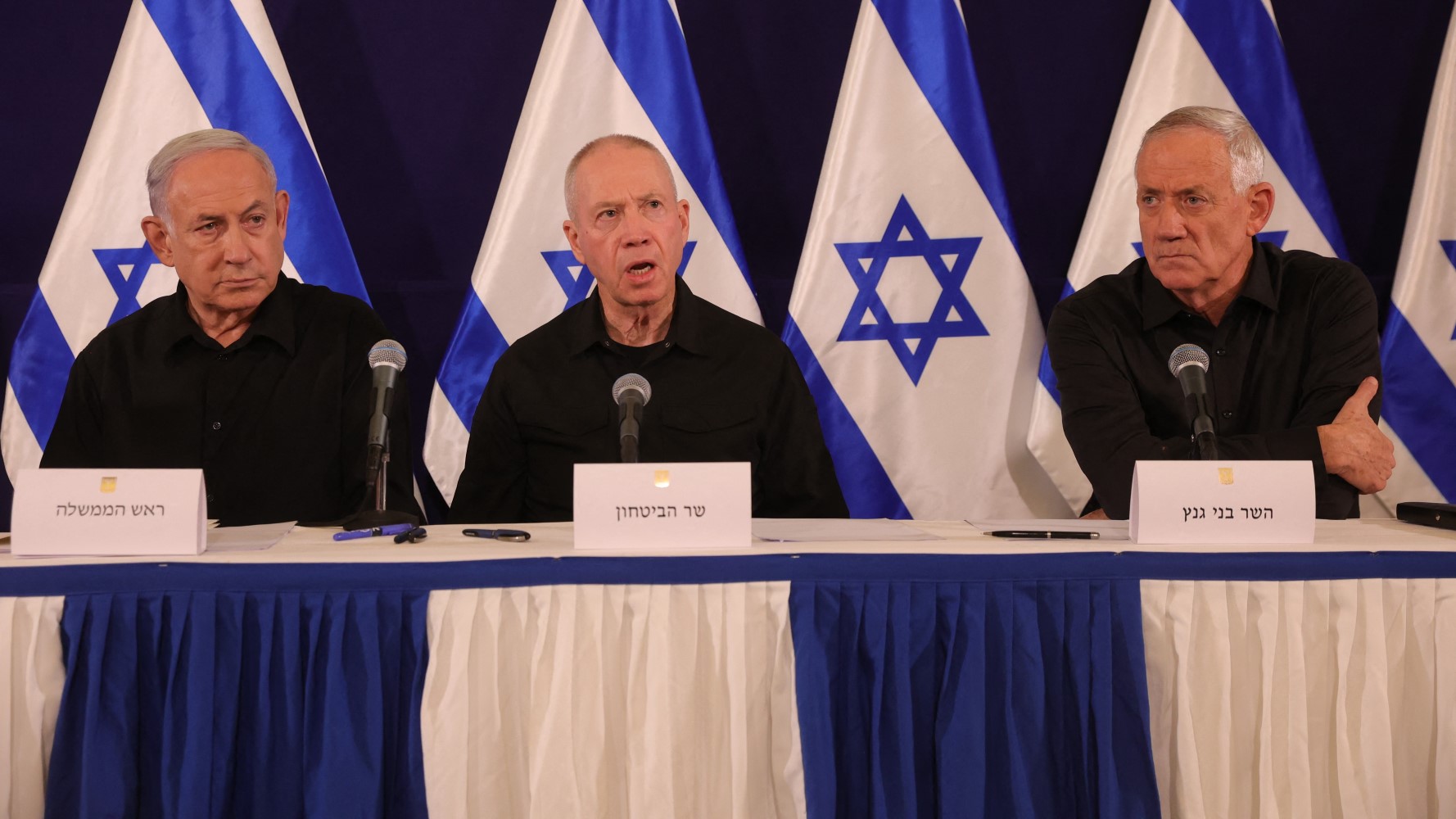 Netanyahu with Defence Minister Yoav Gallant and Benny Gantz, cabinet minister, at a press conference in October 2023 (AFP)